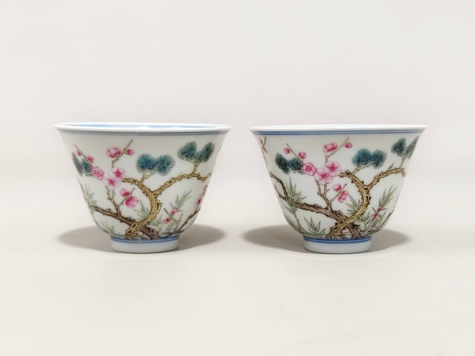 A famille rose pine, bamboo, plum, and bell-shaped cups: A famille rose pine, bamboo, plum, and bell-shaped cup with the mark of "Made in the Yongzheng Reign of the Qing Dynasty". It is 4.5 cm high and 6.3 cm in diameter.