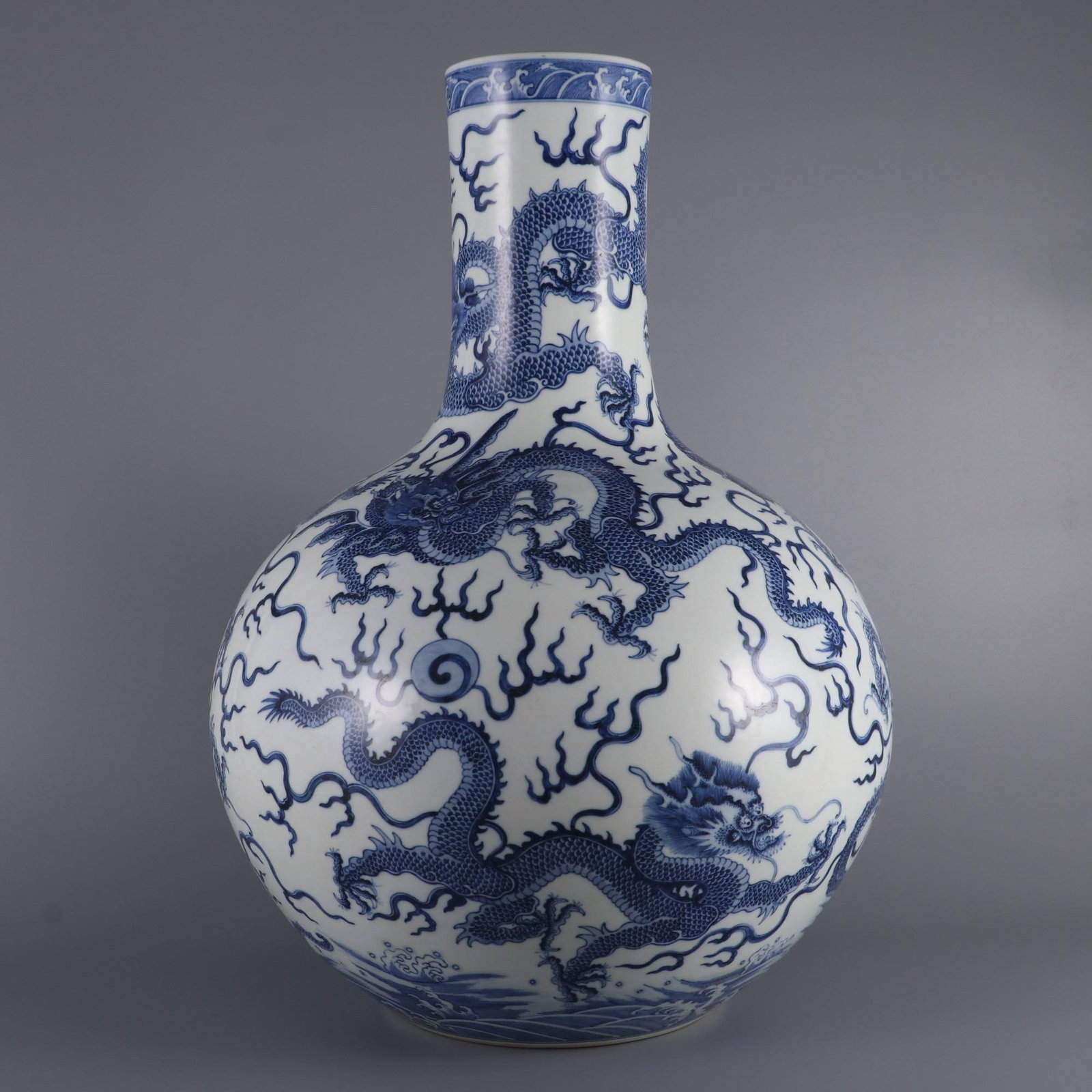 A large blue-and-white porcelain vase with nine dragons design, made during the Qianlong period: A large blue-and-white porcelain vase with nine dragons design, made during the Qianlong period of the Qing dynasty. Dimensions: Height 51.6 cm, belly diameter 36 cm, mouth diameter 11 cm.