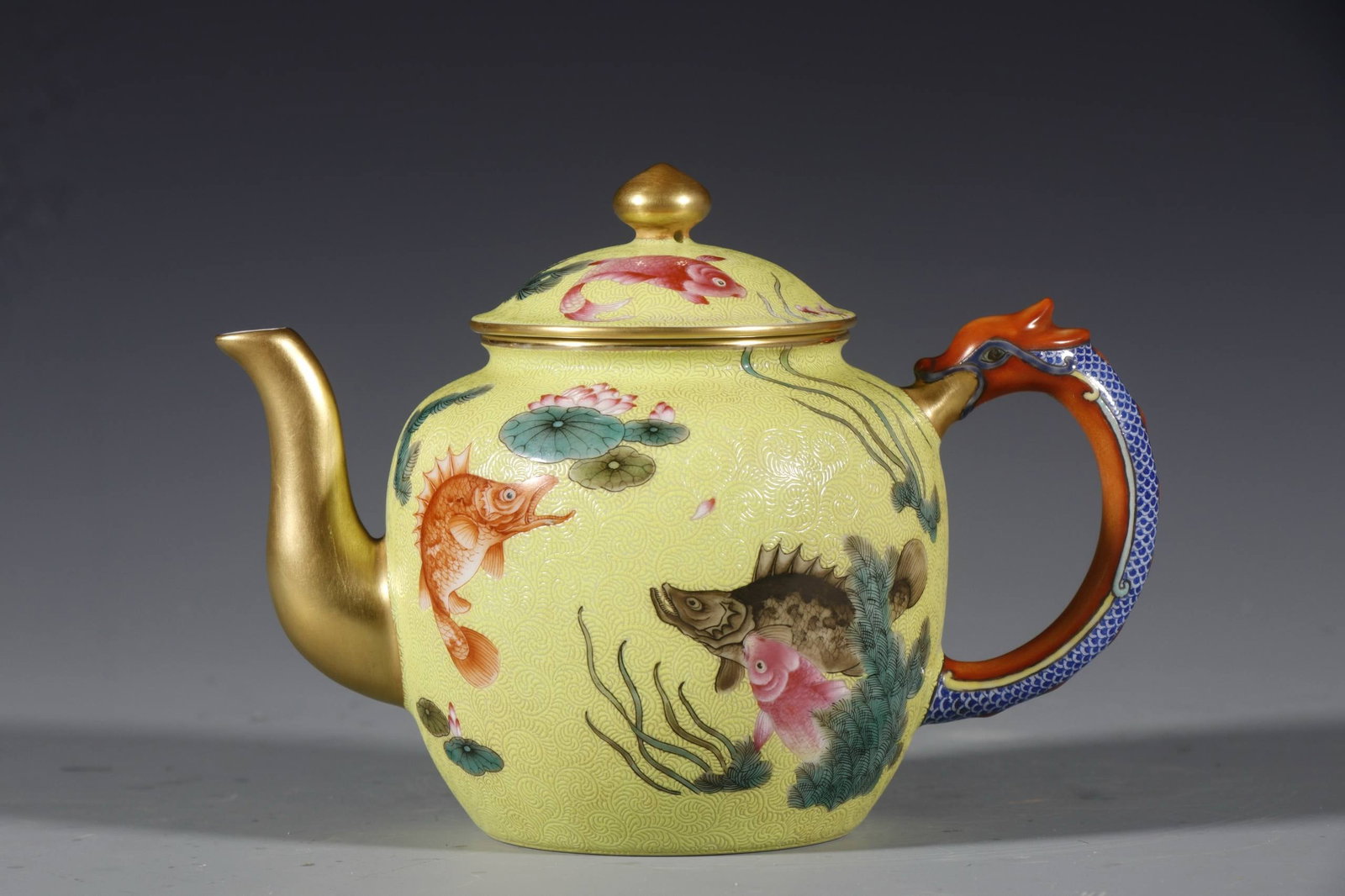 Qing Dynasty, Qianlong Period Yellow-glazed teapot with fish motif symbolizing: Qing Dynasty, Qianlong Period Yellow-glazed teapot with fish motif symbolizing abundance year after year. Height: 12 cm, Mouth diameter: 6.5 cm, Base diameter: 6.5 cm