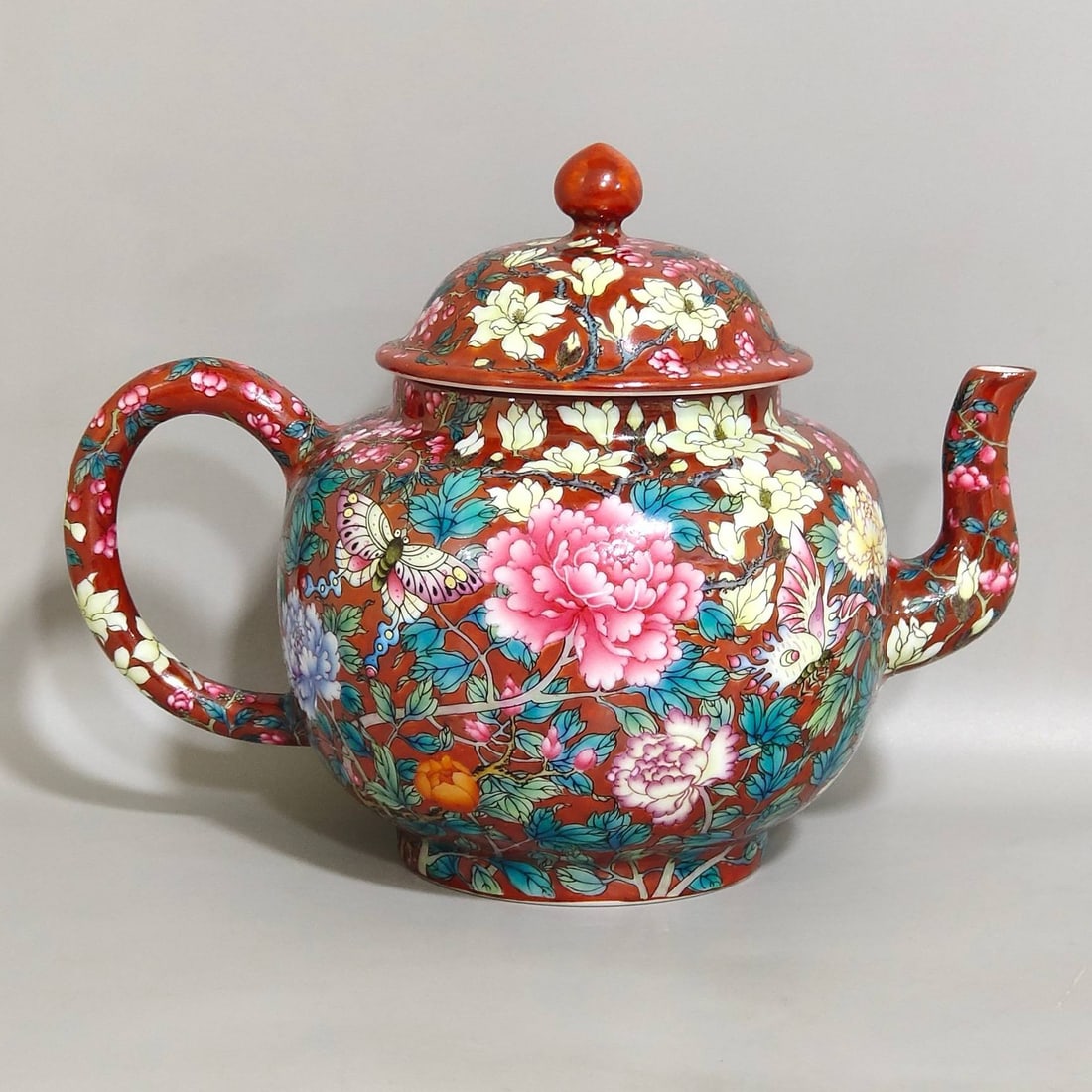 A Qing Dynasty Qianlong period coral red famille rose peony and butterfly teapot (1 of 9)