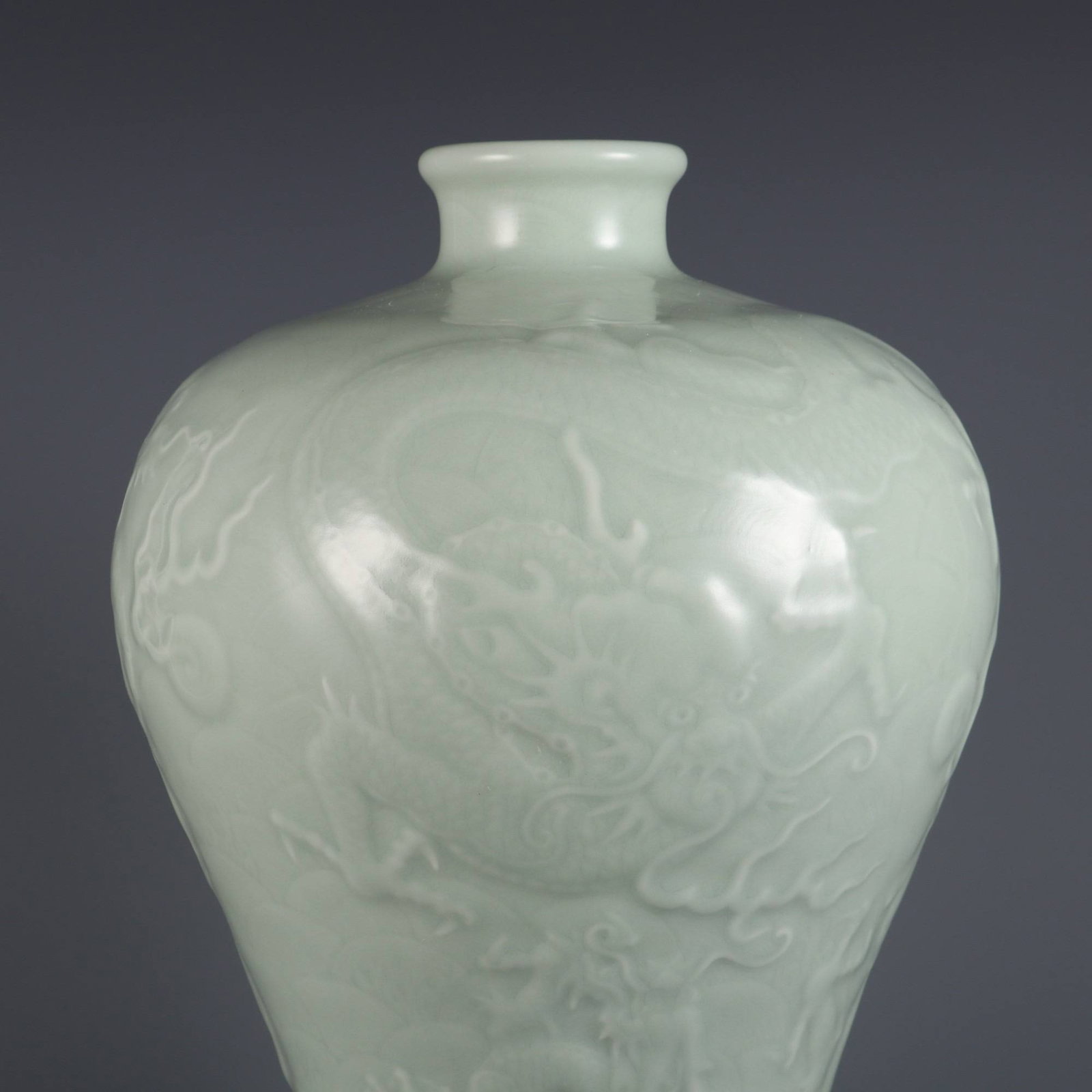 A celadon-glazed plum vase with carved dragon and sea cloud design (1 of 8)