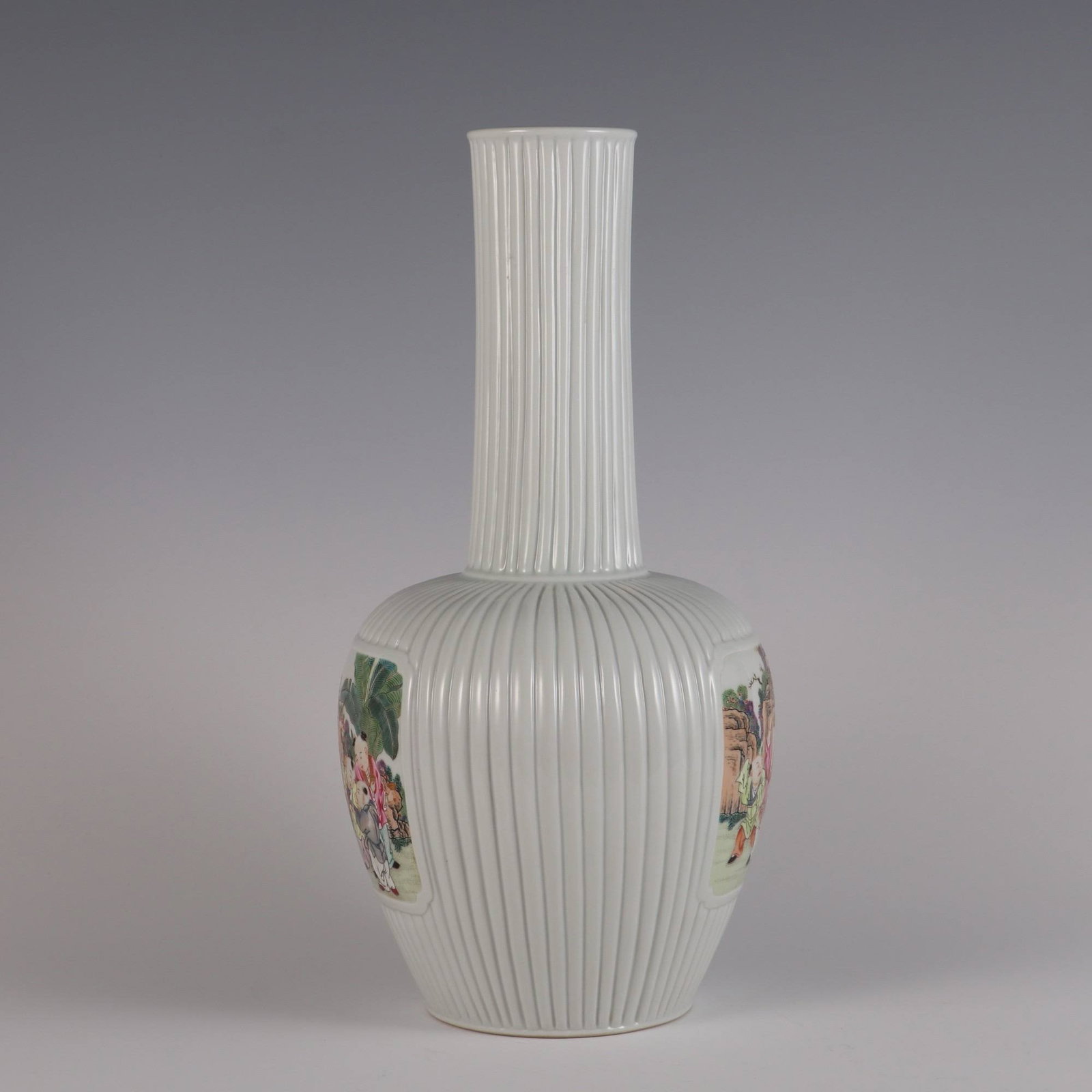 A Qing Dynasty Yongzheng period famille rose vase: A Qing Dynasty Yongzheng period famille rose vase with a design of children playing in a melon shape and openwork design. Dimensions: Height 33.9 cm, belly diameter 16 cm, mouth diameter 6.3 cm.