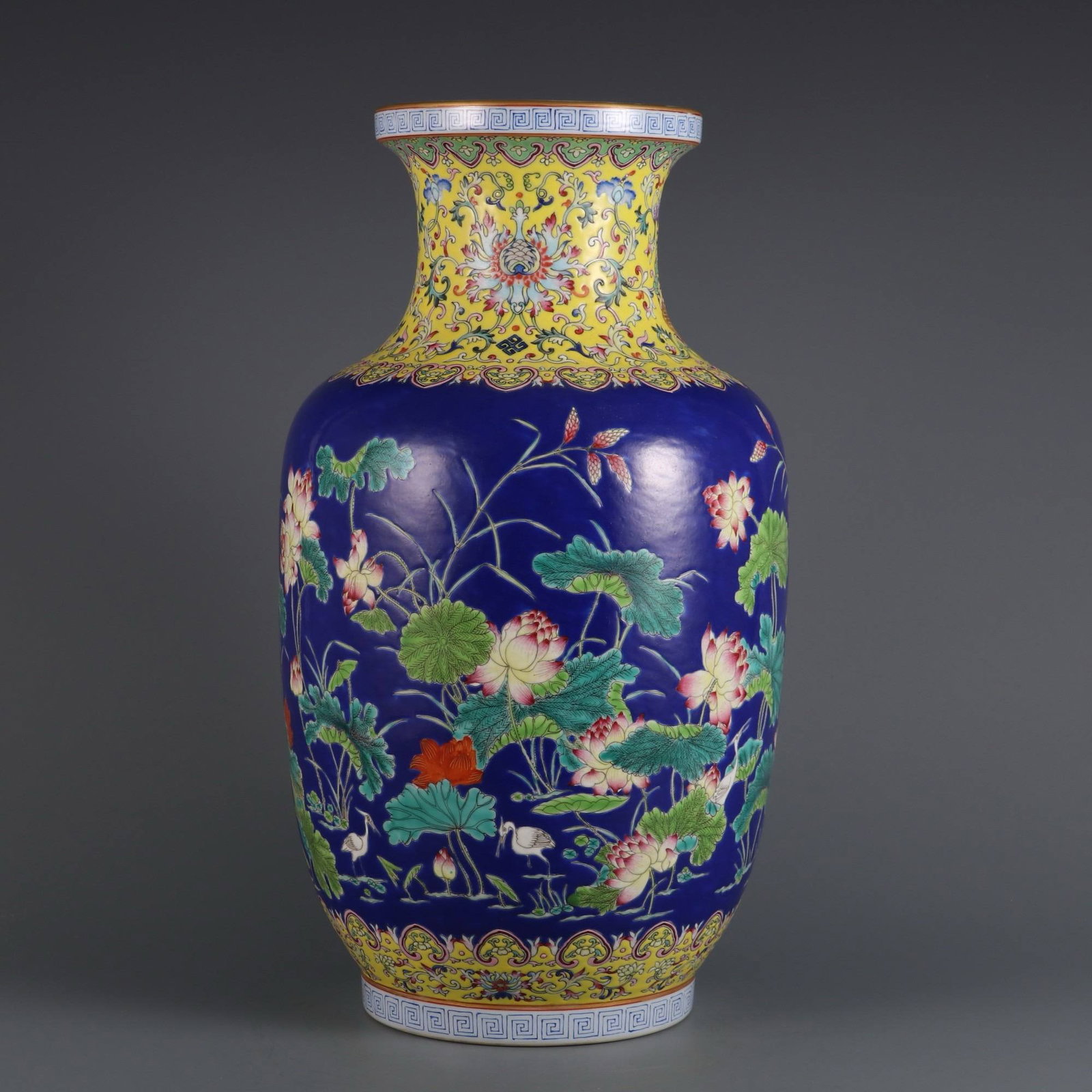 A blue-ground famille rose lotus-patterned cylindrical vase: A blue-ground famille rose lotus-patterned cylindrical vase made during the Qianlong period of the Qing dynasty. Dimensions: Height 37.2 cm, belly diameter 20 cm, mouth diameter 13 cm.