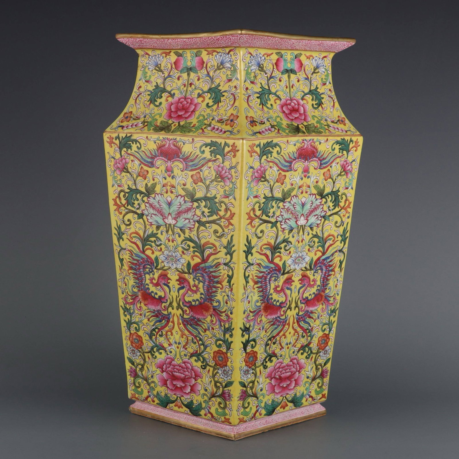 A square vase with a yellow ground and famille rose: A square vase with a yellow ground and famille rose design of phoenixes and peonies, made during the Qianlong period of the Qing dynasty. Dimensions: Height 40.5 cm, Mouth Diameter 18 cm.