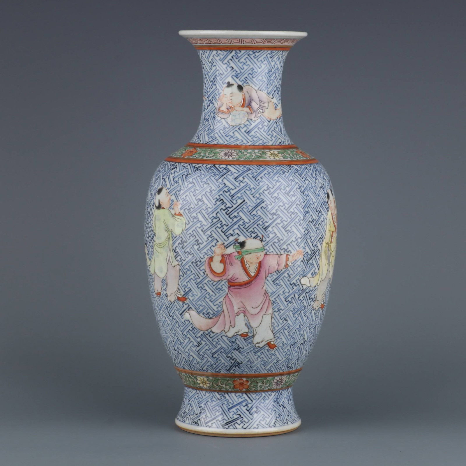 A Qing Dynasty Qianlong period blue and white porcelain vase: A Qing Dynasty Qianlong period blue and white porcelain vase with famille rose enamels depicting children at play. Dimensions: Height 32.3 cm, Mouth Diameter 10.2 cm.
