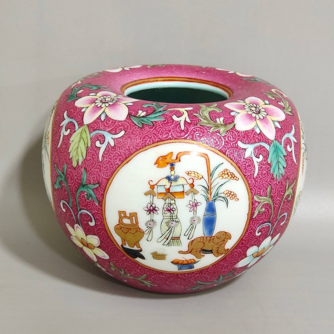 A Qing Dynasty Daoguang period rouge-red water bowl: A Qing Dynasty Daoguang period rouge-red water bowl with openwork floral design and the symbol of abundant harvests, measuring 7.5 cm in height and 9.5 cm in diameter.