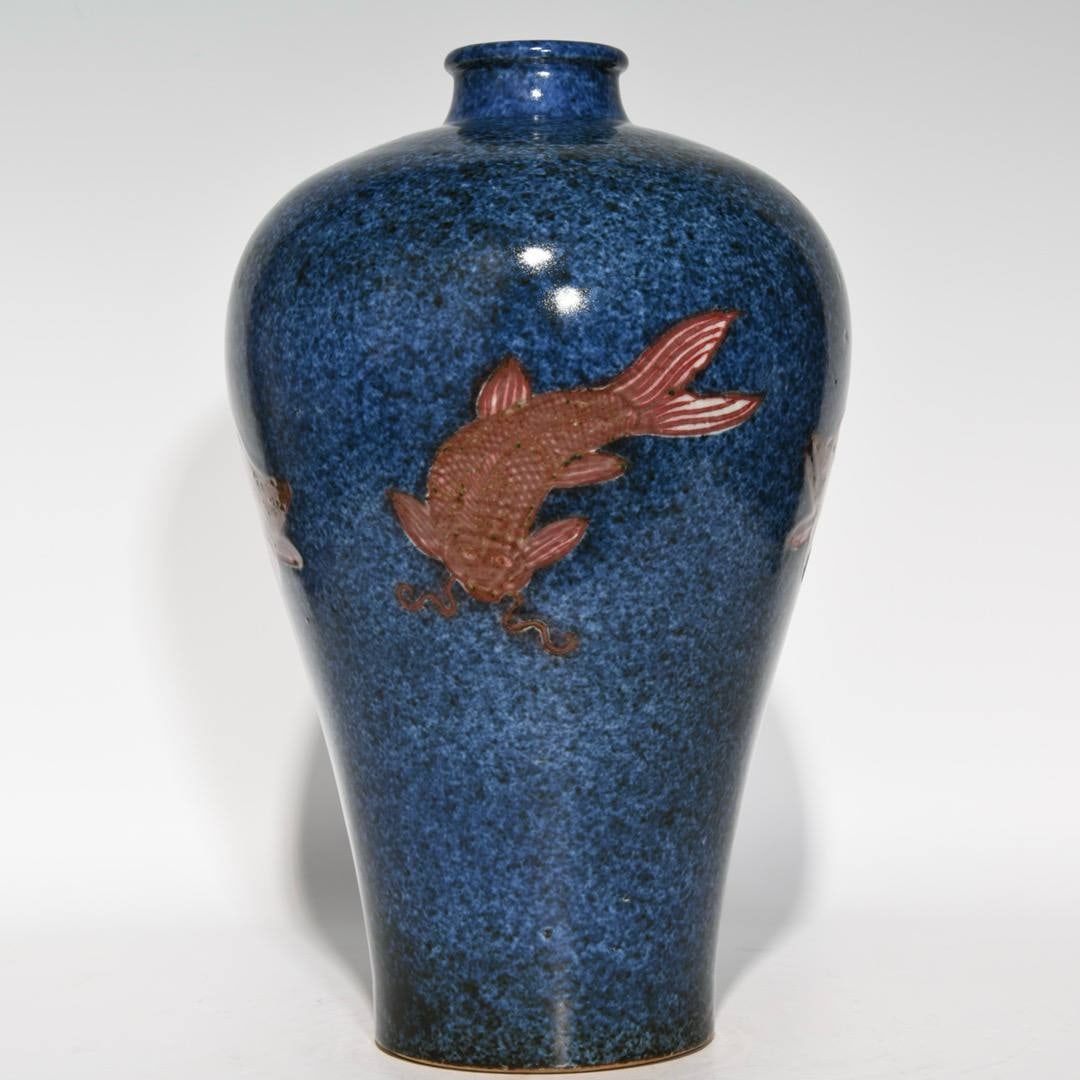 A Ming Dynasty Xuande period snowflake-blue ground underglaze red fish-patterned plum vase: A Ming Dynasty Xuande period snowflake-blue ground underglaze red fish-patterned plum vase, 31.5cm high and 21cm in diameter.