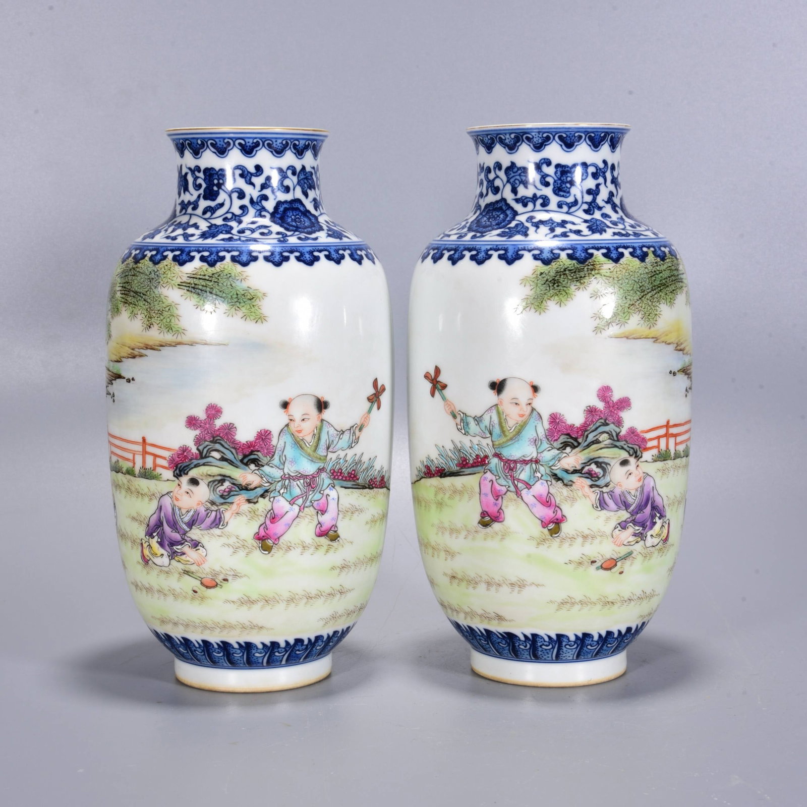 A Qing Dynasty Qianlong period blue and white famille rose vase: A Qing Dynasty Qianlong period blue and white famille rose vase with a design of children, 21 x 10 cm.