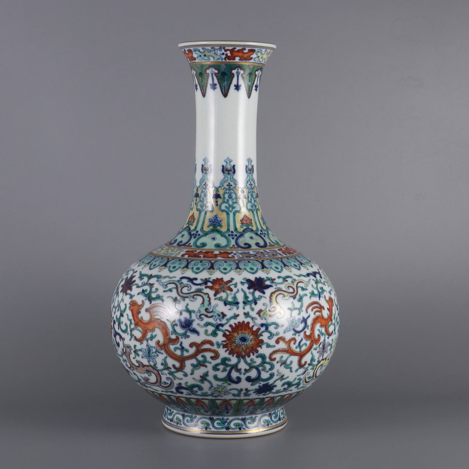 A Qianlong-era (1736-1745) doucai vase: A Qianlong-era (1736-1745) doucai vase with lotus and phoenix scroll design. Dimensions: Height 39 cm, Belly diameter 22.5 cm, Mouth diameter 9.6 cm.