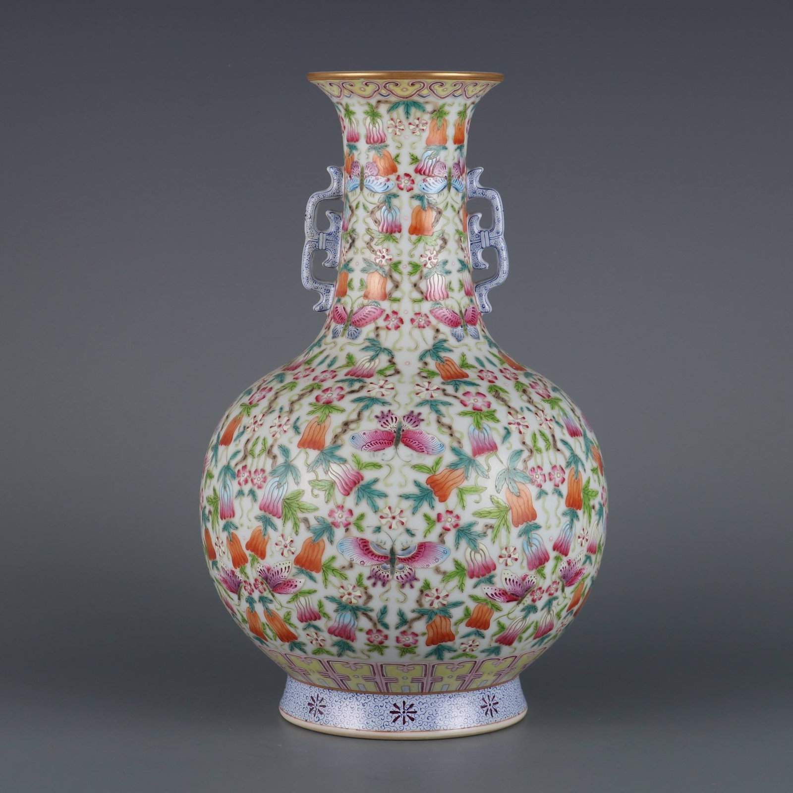 A famille rose vase with melon and butterfly handles: A famille rose vase with melon and butterfly handles, made during the Qianlong period of the Qing dynasty. Dimensions: Height 30.2 cm, Mouth Diameter 9 cm.