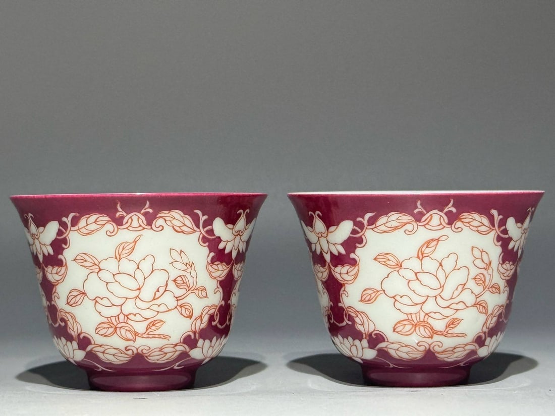A Qing Dynasty Yongzheng period (1736-1762) imperial enamel cups: A Qing Dynasty Yongzheng period (1736-1762) imperial enamel cups with a rouge-red ground and openwork panels depicting lightly painted floral sprays. Height: 5.2cm Width: 7cm