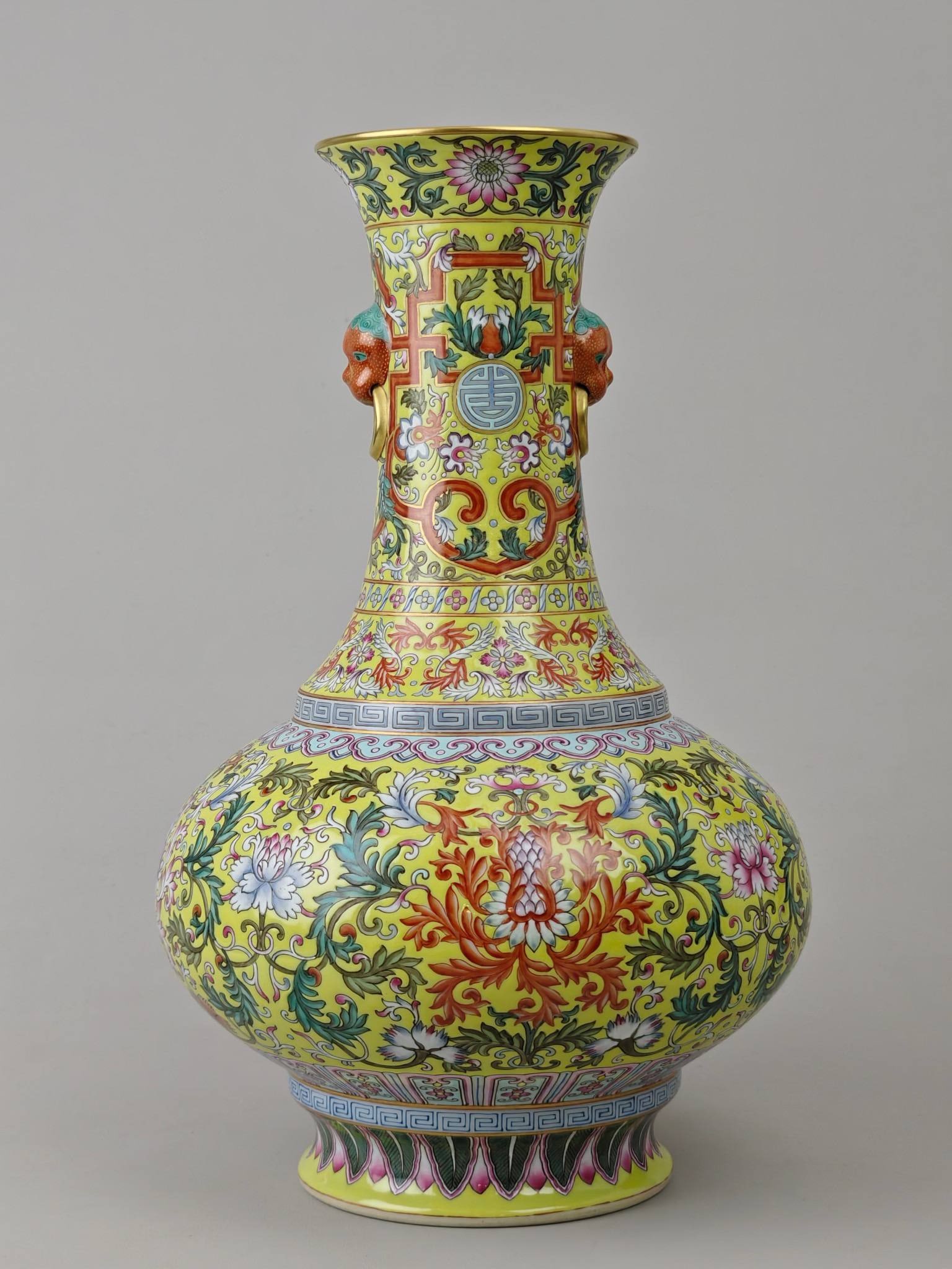 A famille rose vase with a yellow background and double handles: A famille rose vase with a yellow background and double handles, made during the Qianlong period of the Datong era. It measures 35.6 cm in height and 22 cm in diameter.