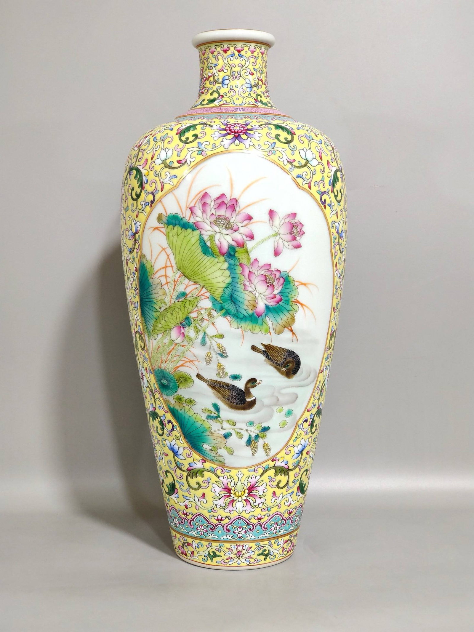 A Qing Dynasty Yongzheng period vase: A Qing Dynasty Yongzheng period yellow-ground mandarin duck and lotus plum vase, 33 cm high and 15 cm in diameter.