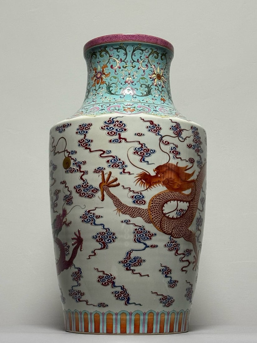A famille rose vase with a turquoise ground and lotus scroll and dragon: A famille rose vase with a turquoise ground and lotus scroll and dragon and son motif, bearing the mark of the Qianlong period of the Qing dynasty. Height: 58.5cm Width: 33cm
