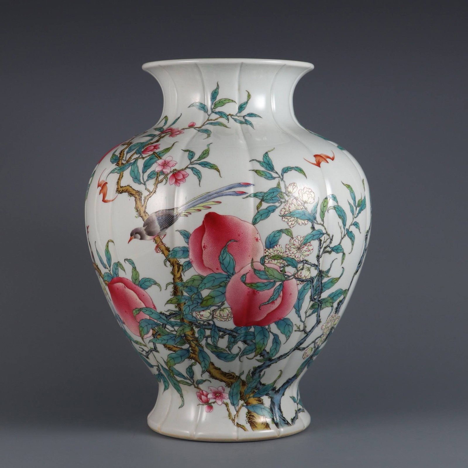 A famille rose vase with eight peaches and birds design: A famille rose vase with eight peaches and birds design, made during the Yongzheng period of the Qing dynasty. Dimensions: Height 33.5 cm, Mouth Diameter 15.6 cm.