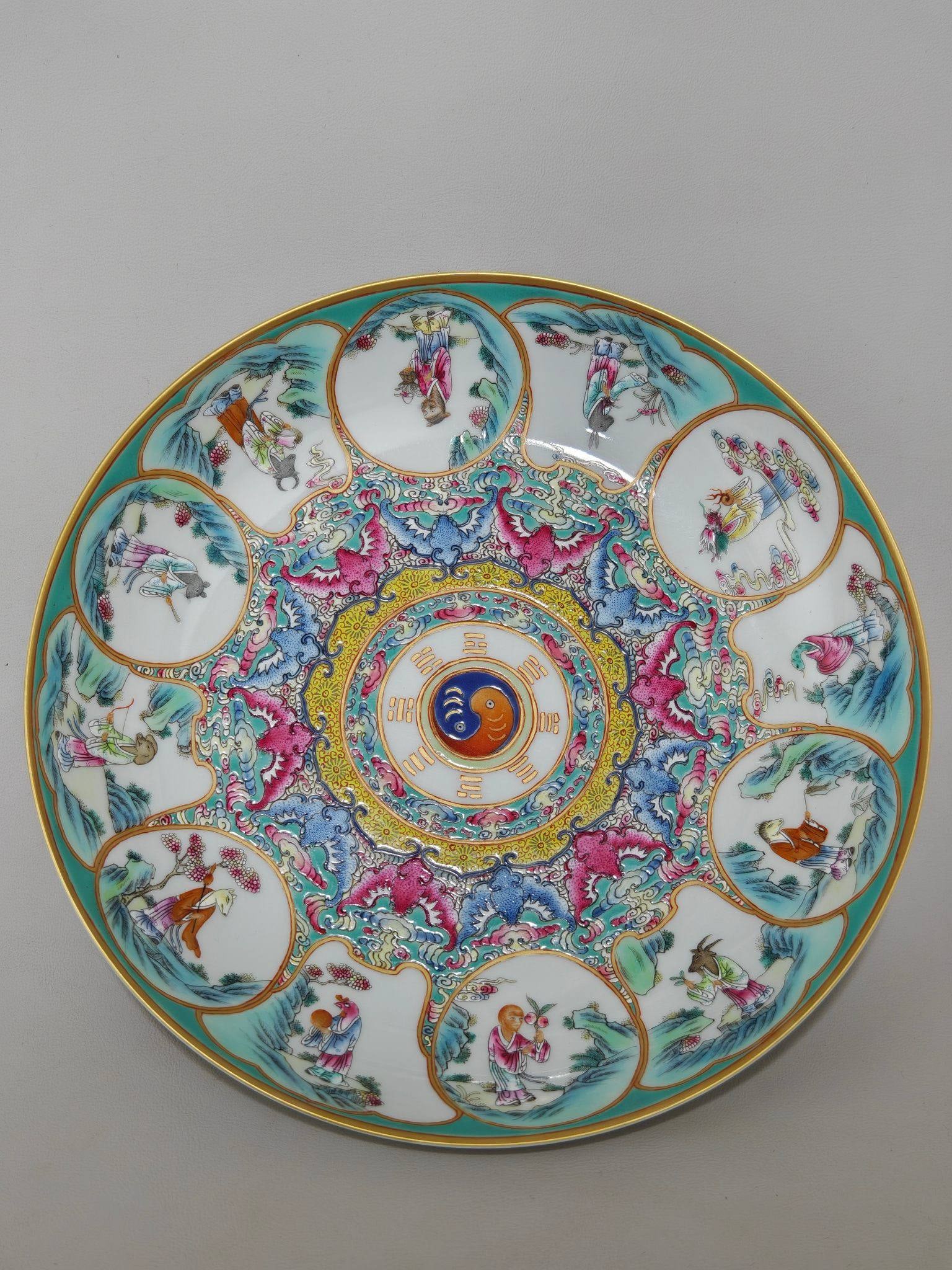 A famille rose plate with figures of the twelve zodiac animals: A famille rose plate with figures of the twelve zodiac animals, made during the Yongzheng reign of the Qing Dynasty. Height: 5 cm, Diameter: 23.6 cm.