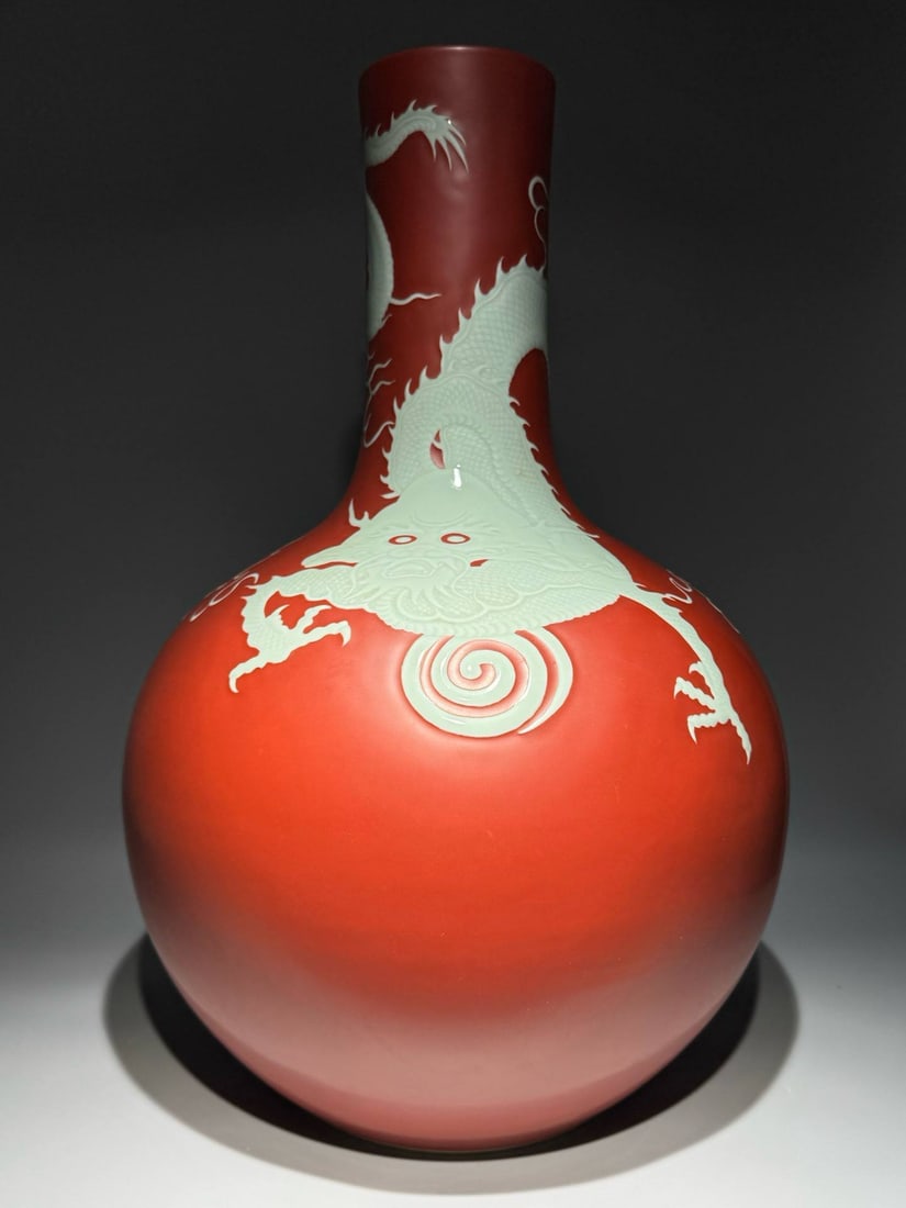 Qing Dynasty, Qianlong period, vanadium red with white carved dragon pattern: Qing Dynasty, Qianlong period, vanadium red with white carved dragon pattern celestial globe vase. Height: 63cm, Width: 40cm