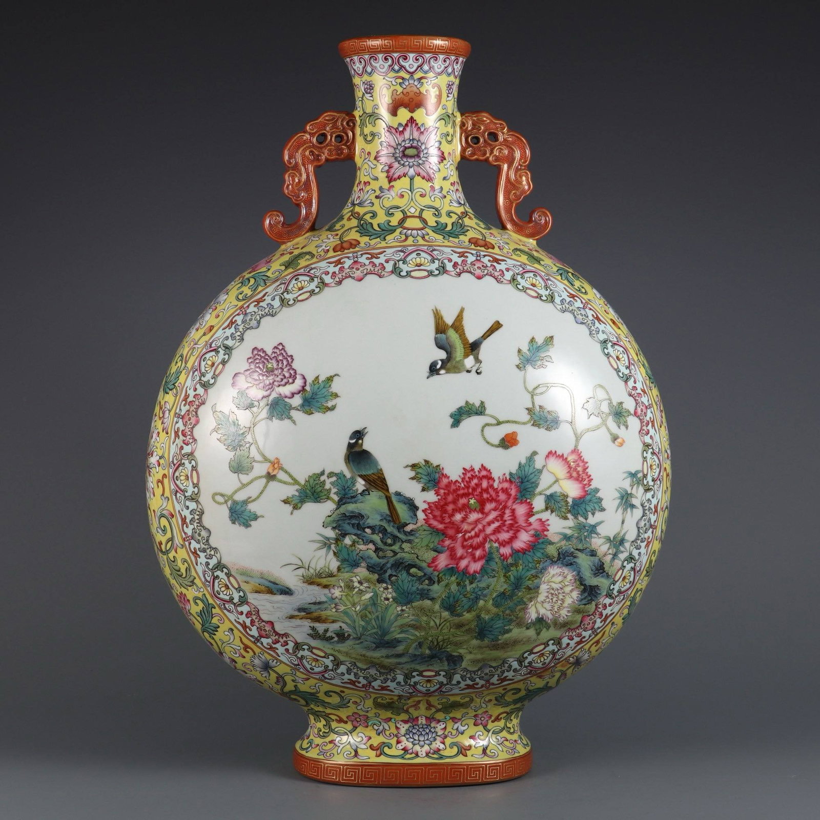 A large, flattened vase with famille rose enamels depicting lotus scrolls: A large, flattened vase with famille rose enamels depicting lotus scrolls, openwork floral and bird designs, made during the Qianlong period of the Qing dynasty. Dimensions: Height 48 cm, Belly diamet