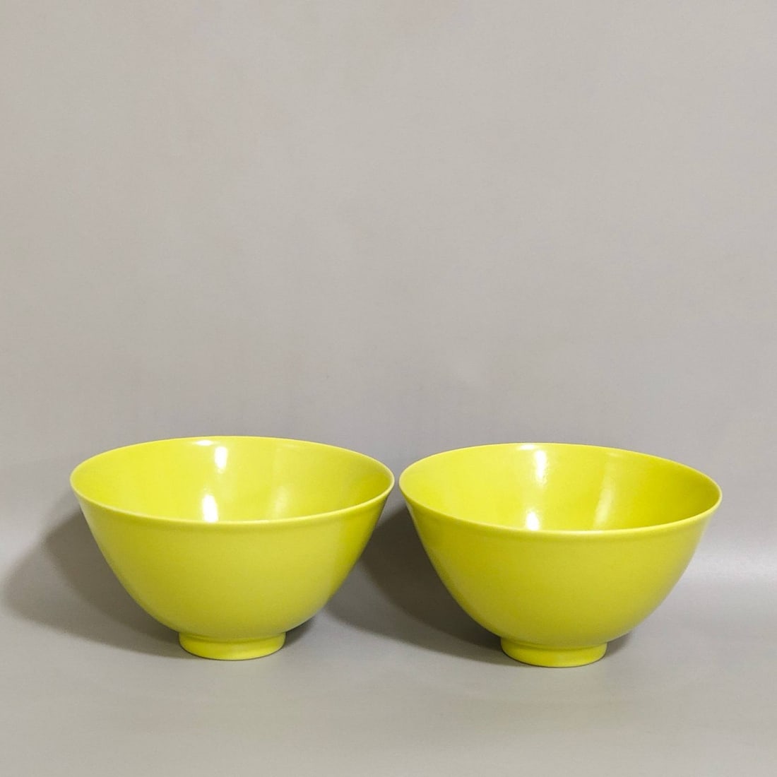 A Qing Dynasty Qianlong period lemon-yellow glazed tea cake: A Qing Dynasty Qianlong period lemon-yellow glazed tea cake, 5.1 cm high and 9.2 cm in diameter.