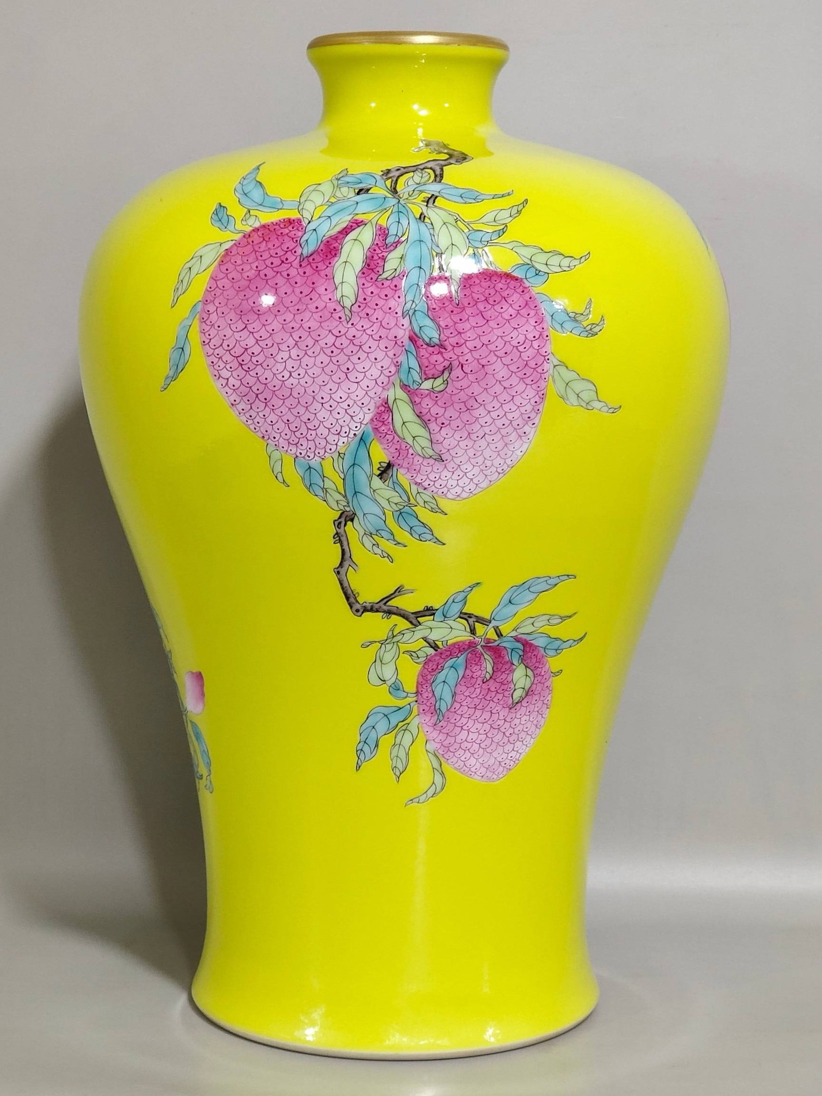 A Qing Dynasty Yongzheng period lemon-yellow glazed plum vase: A Qing Dynasty Yongzheng period lemon-yellow glazed plum vase with three auspicious symbols, 28 cm high and 17 cm in diameter.