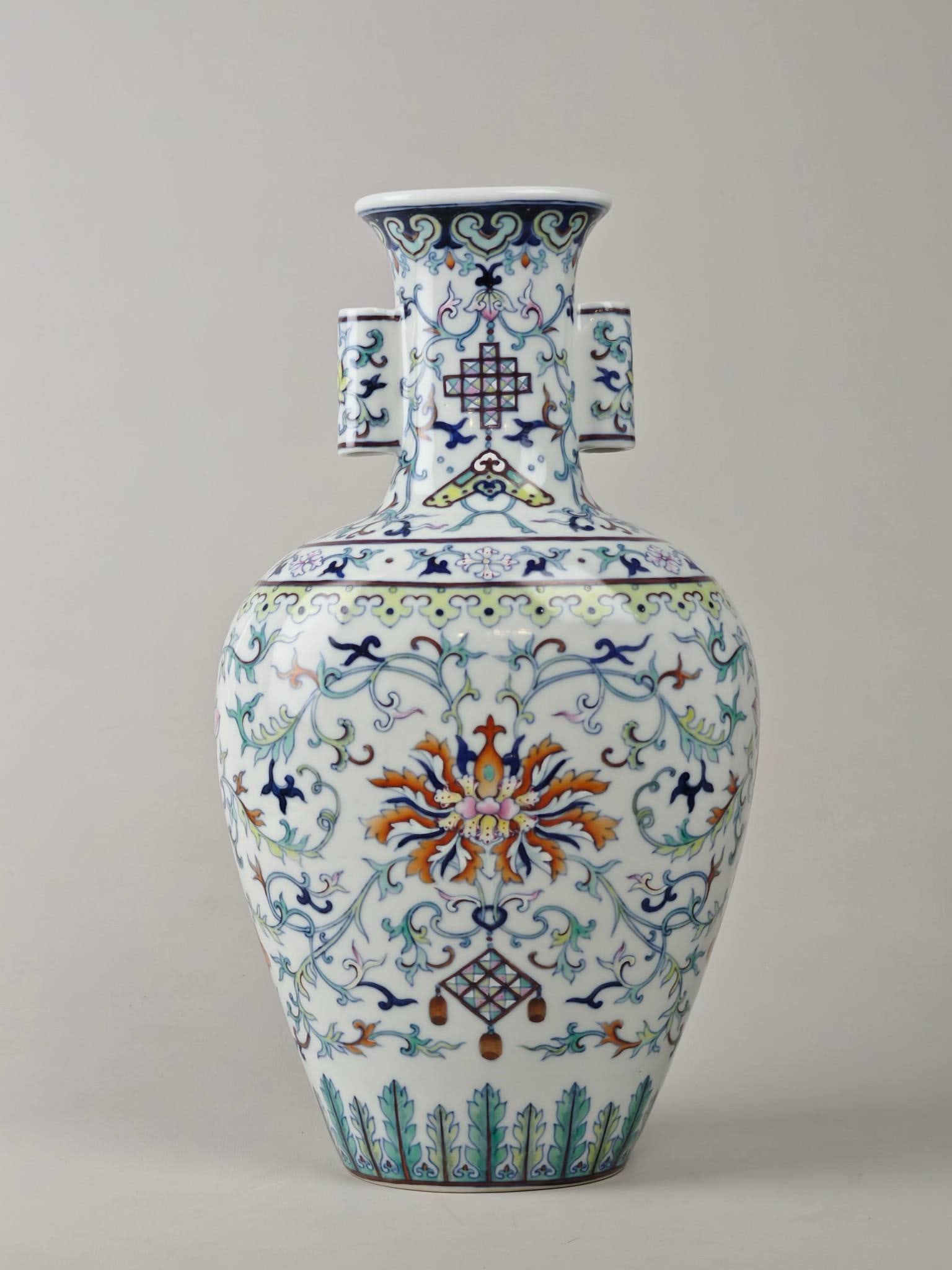A doucai vase with lotus scroll design: A doucai vase with lotus scroll design, bearing the mark of the Qianlong period of the Qing Dynasty, measuring 32 cm in height and 18 cm in diameter.