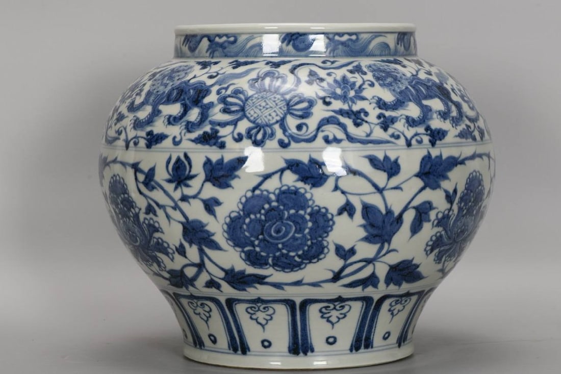 A Yuan Dynasty blue-and-white porcelain jar: A Yuan Dynasty blue-and-white porcelain jar with peony and lotus scroll design, 28 cm high, 20.5 cm in diameter at the mouth, 32 cm in diameter at the belly, and 19 cm in diameter at the base.