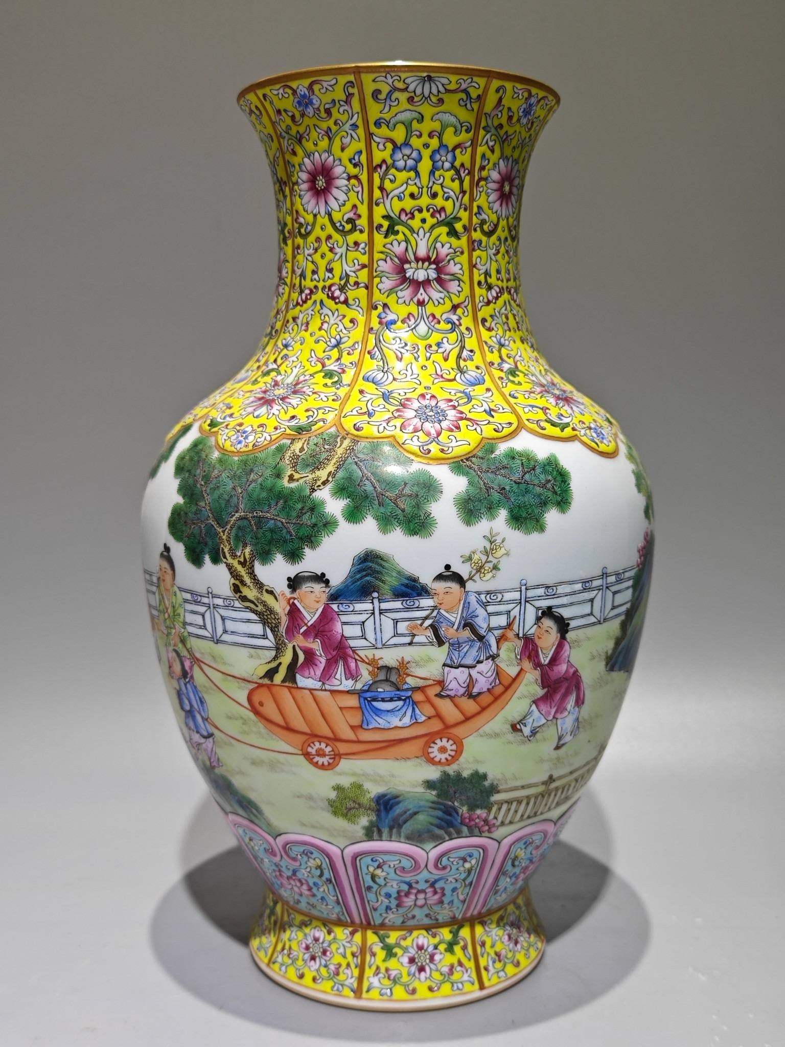 A famille rose enamel vase: A famille rose enamel vase with a yellow ground, decorated with lotus scrolls, cherry blossoms, melons, and gilt decoration, measuring 31cm in height and 18cm in diameter at the base. Made during the 