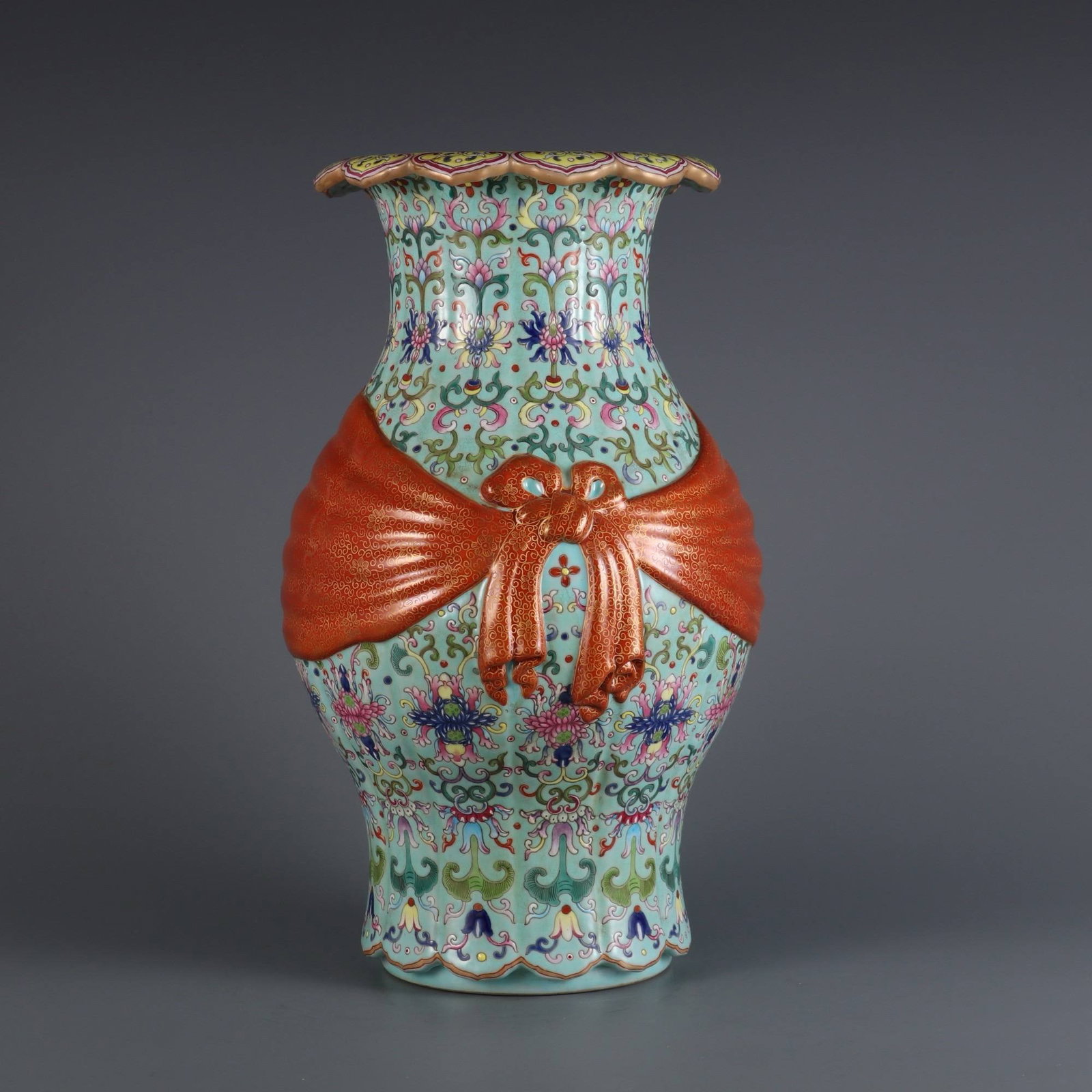 A Qing Dynasty Qianlong Period Green-Ground Famille Rose Vase: A Qing Dynasty Qianlong Period Green-Ground Famille Rose Vase with Passionflower Design and Ribbon Design. Dimensions: Height 32 cm, Belly Diameter 17 cm, Mouth Diameter 13 cm.