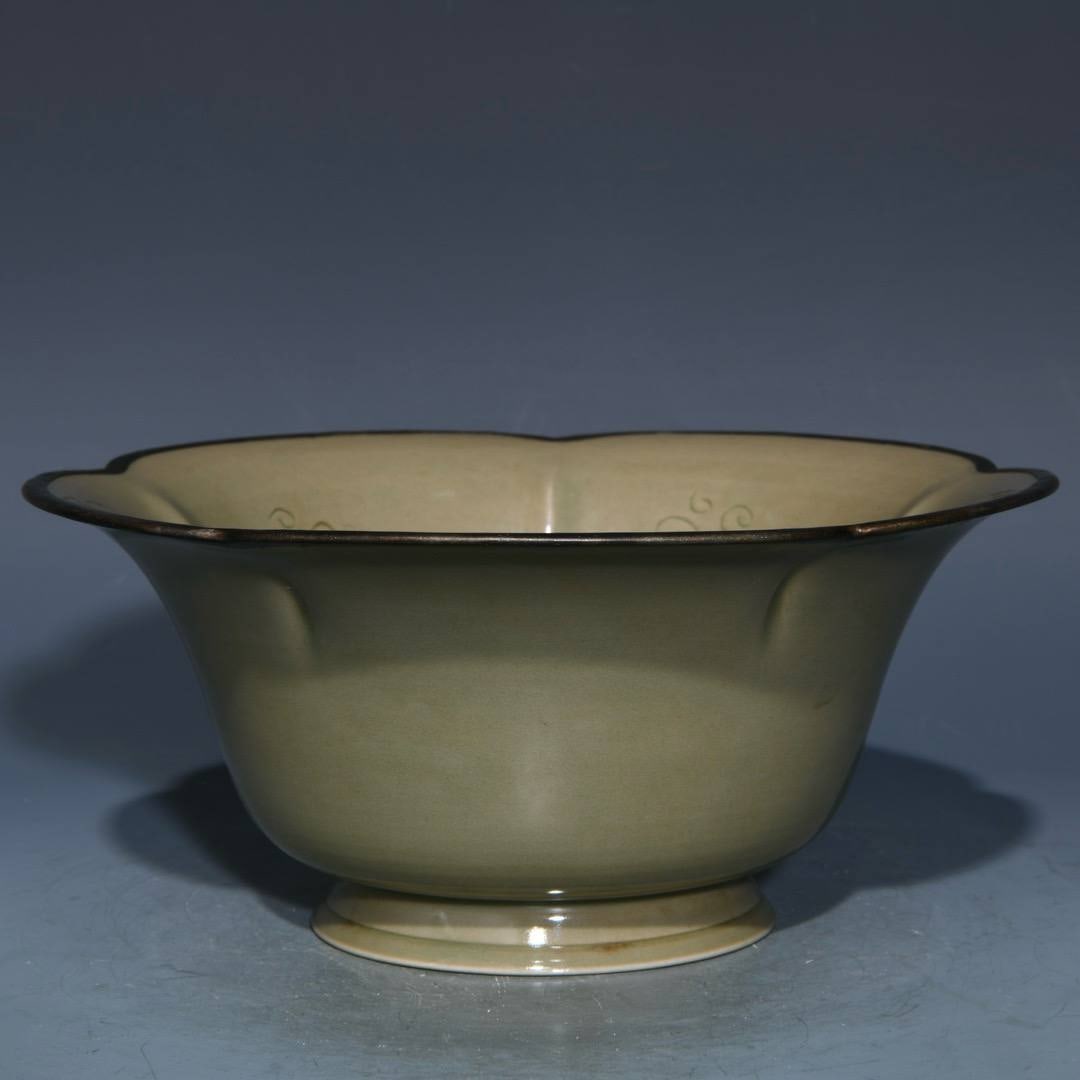 A Yue ware carved bowl with a rim: A Yue ware carved bowl with a rim, 9.6cm high and 21.5cm in diameter.
