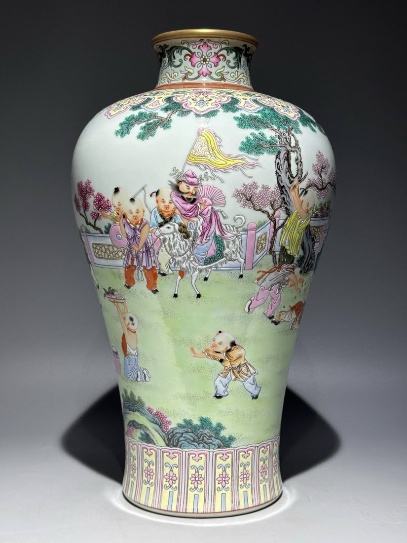 A Qing Dynasty Yongzheng period famille rose plum vase: A Qing Dynasty Yongzheng period famille rose plum vase with a design of children at play and an inscription of poetry. Height: 36.8cm Width: 20.6cm
