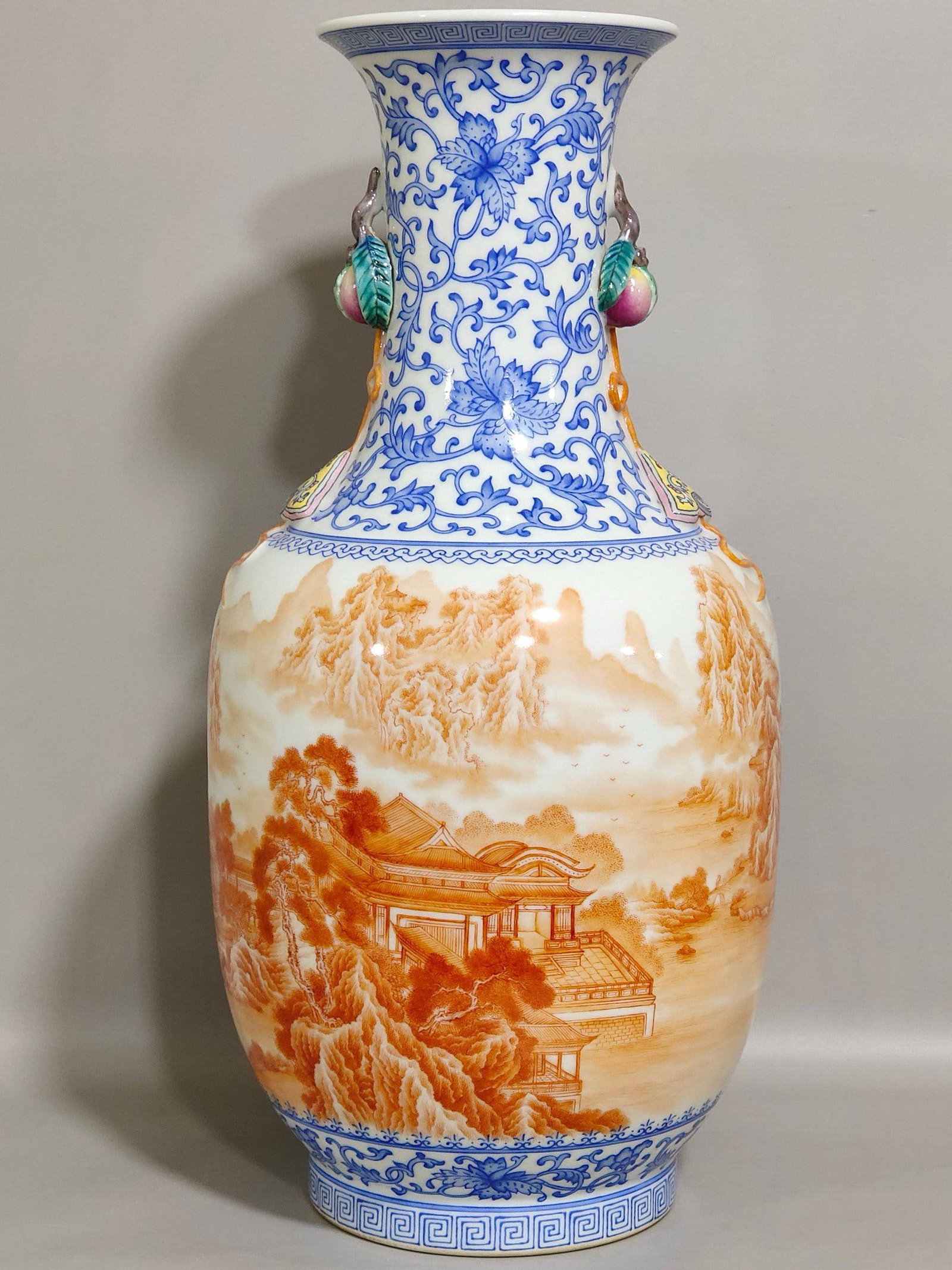 A Qing Dynasty Qianlong period blue and white porcelain vase: A Qing Dynasty Qianlong period blue and white porcelain vase with iron-red landscape and pavilion design and inscription, 34.5 cm high and 16 cm in diameter.