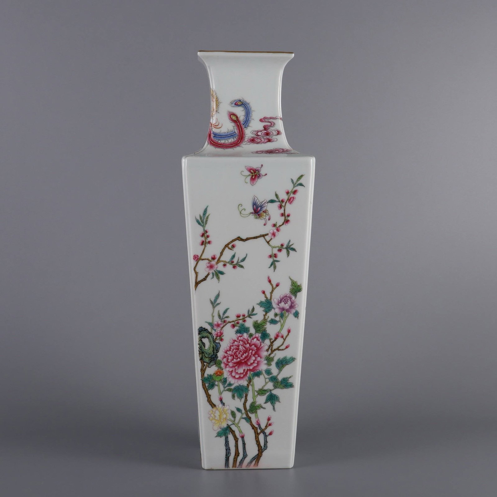 A square vase with famille rose enamels depicting flowers of the four seasons: A square vase with famille rose enamels depicting flowers of the four seasons, made during the Qianlong period of the Qing dynasty. Dimensions: Height 35 cm, belly diameter 11 cm, mouth diameter 7.8 c