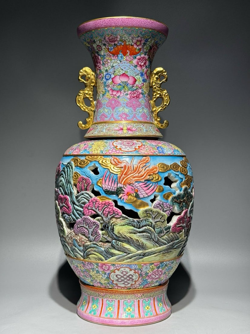 A Qing Dynasty Qianlong period (1736-1745) famille rose enamel revolving vase: A Qing Dynasty Qianlong period (1736-1745) famille rose enamel revolving vase with openwork phoenix design on a floral ground. Height: 45cm, Width: 21.5cm