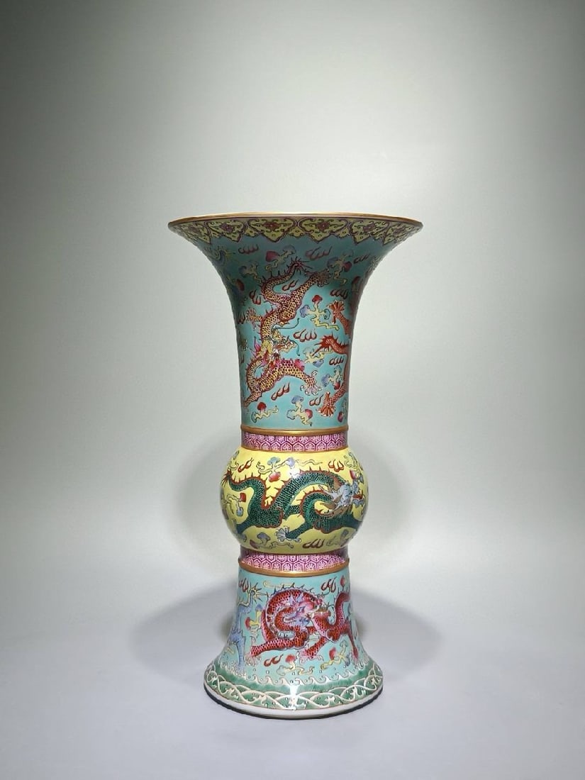 A famille rose vase with a Qianlong mark (1736-1745): A famille rose vase with a Qianlong mark (1736-1745), decorated with nine dragons amidst waves and clouds. Height: 31cm, Width: 16.6cm