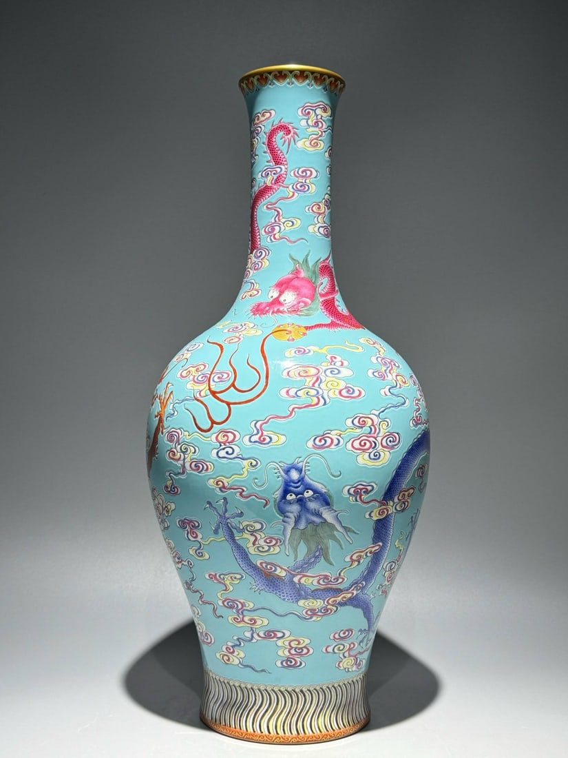 A famille rose vase with a turquoise ground and a design of phoenixes: A famille rose vase with a turquoise ground and a design of phoenixes and dragons offering longevity symbols amidst intertwined floral patterns, bearing the mark of the Qianlong period (1760s). Height