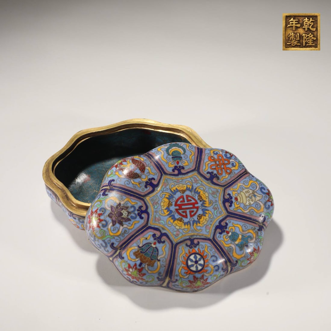 A Qing Dynasty Cloisonné Enamel Melon-Shaped Box with Eight Treasures Design: Height 8cm, Diameter 19cm, Weight 2600gMade in the Qianlong Period.