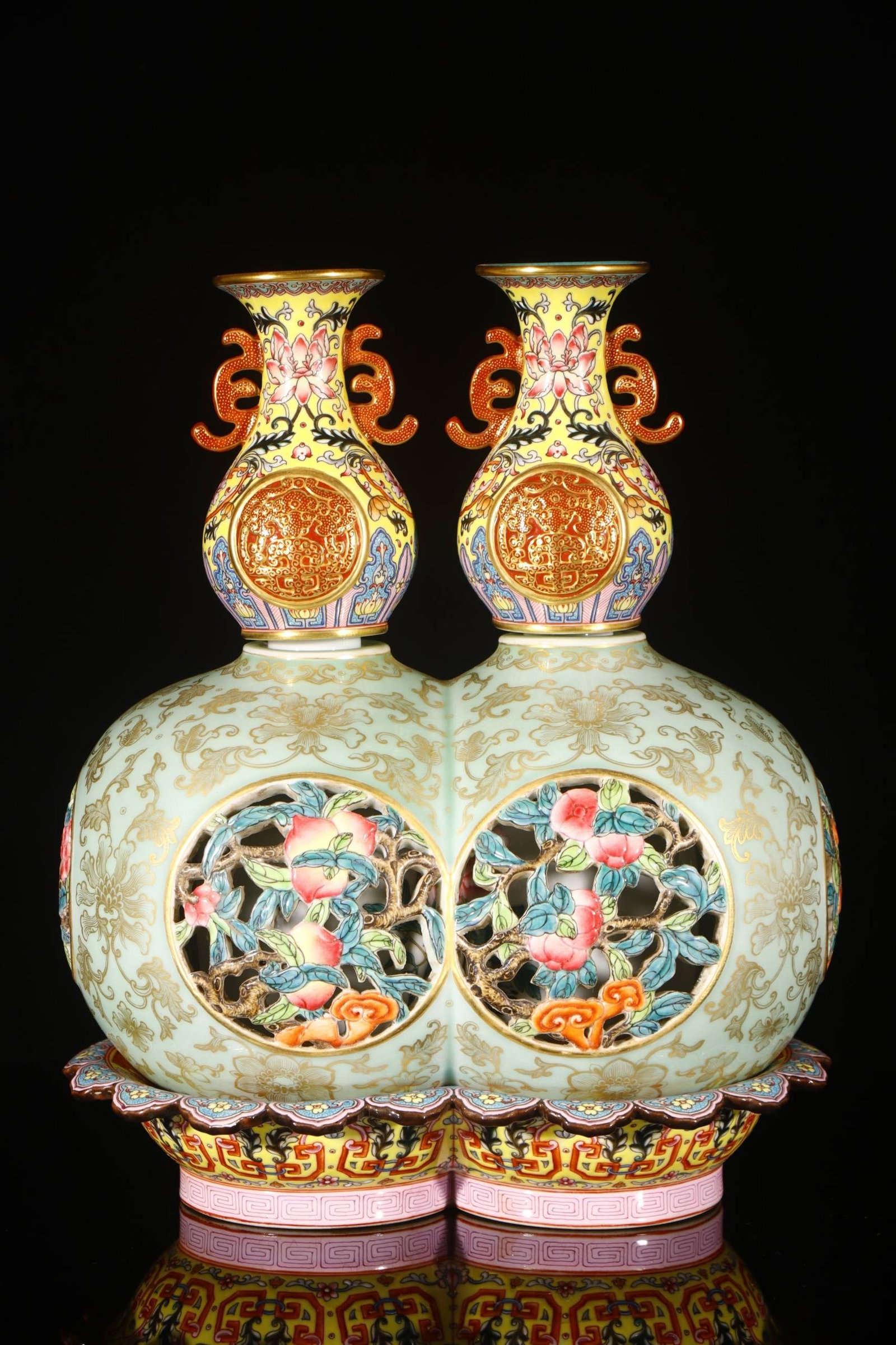 Qing Dynasty, Qianlong Period: Twin celadon gourd-shaped revolving vases: Qing Dynasty, Qianlong Period: Twin celadon gourd-shaped revolving vases, 30.5 cm high, 5.5 cm in mouth diameter, 17.5 cm in base diameter.