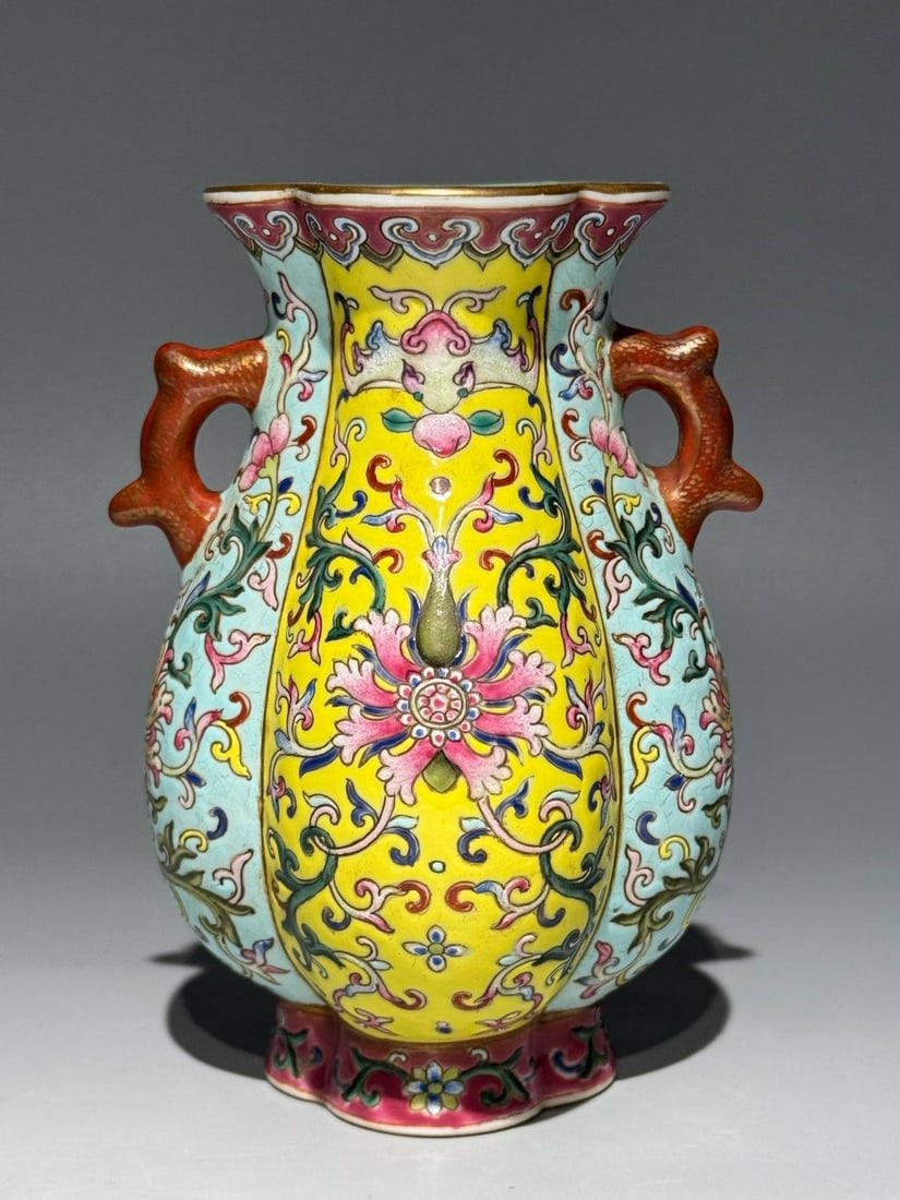 A famille rose vase with lotus scroll design and double handles: A famille rose vase with lotus scroll design and double handles, bearing the mark of the Jiaqing period of the Qing dynasty. Height: 13cm, Width: 8.3cm