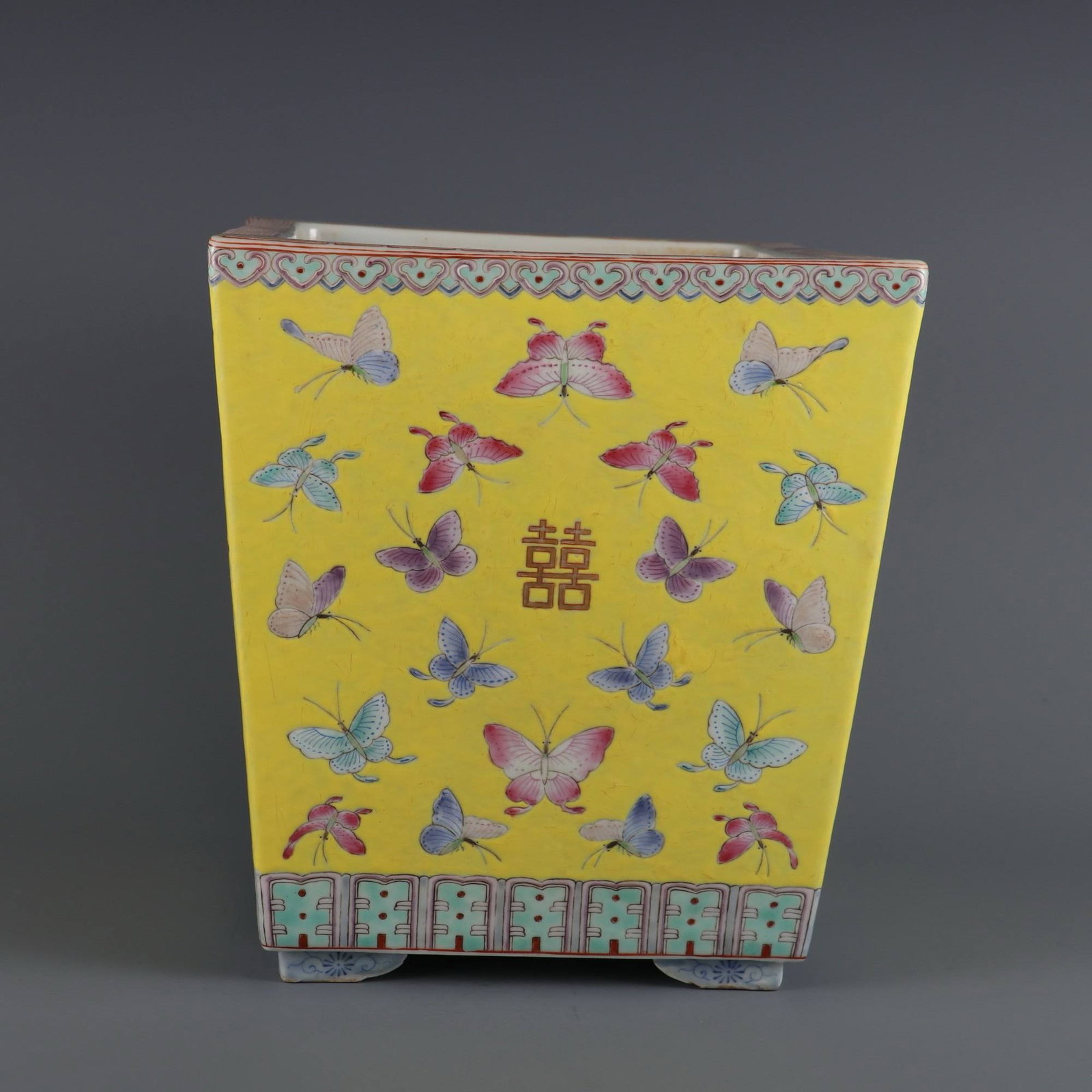 A square flowerpot with a yellow ground and famille rose: A square flowerpot with a yellow ground and famille rose decoration of butterflies and double happiness characters, made during the Tongzhi period of the Qing Dynasty. Dimensions: Height 25 cm, Length