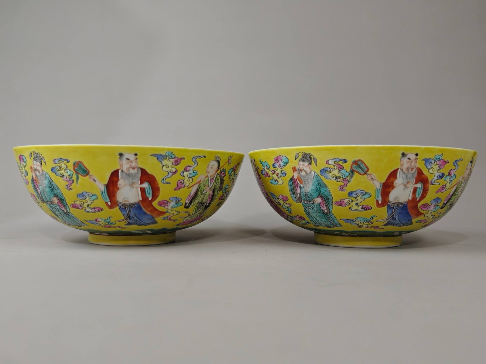 A famille rose bowls with a yellow background and figures of the Eight Immortals: A famille rose bowls with a yellow background and figures of the Eight Immortals , made by Shengdetang. Height: 8 cm, Diameter: 20.1 cm.