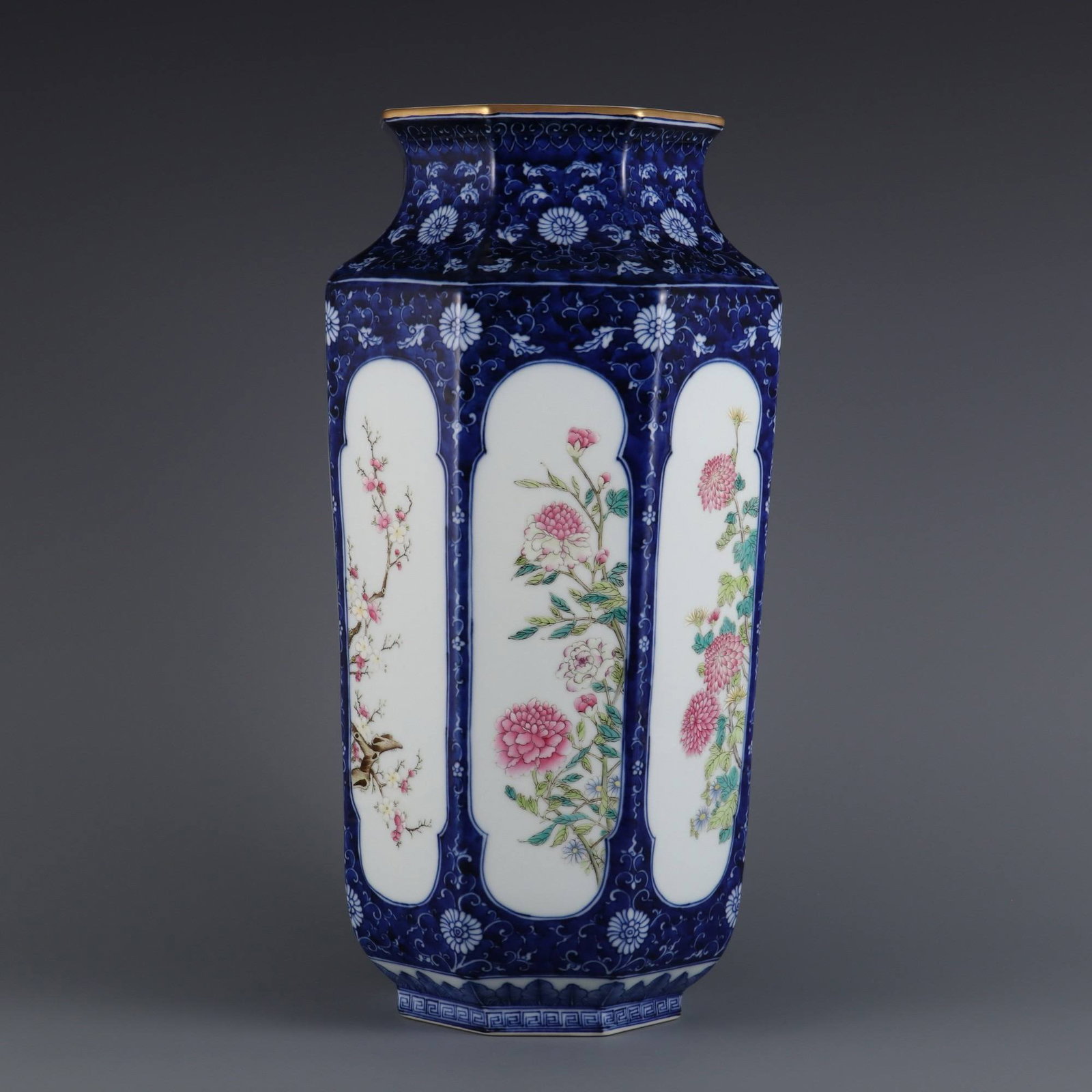A blue-and-white octagonal vase with chrysanthemum and floral design: A blue-and-white octagonal vase with chrysanthemum and floral design on a blue ground, made during the Qianlong period of the Qing dynasty. Dimensions: Height 39.8 cm, Mouth Diameter 14.6 cm.