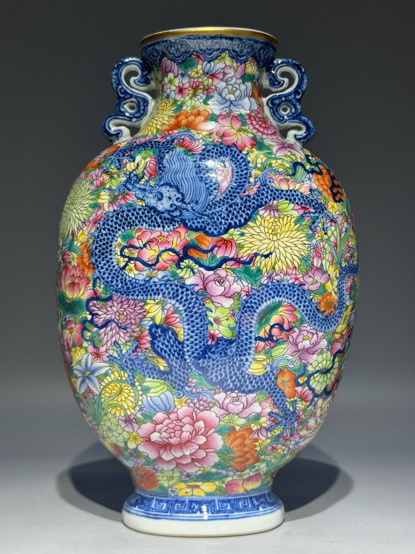 A Qing Dynasty Qianlong period blue and white famille rose double-eared flat vase: A Qing Dynasty Qianlong period blue and white famille rose double-eared flat vase with auspicious dragon and phoenix motifs amidst a myriad of floral patterns. Height: 26cm, Width: 16cm, Thickness: 11