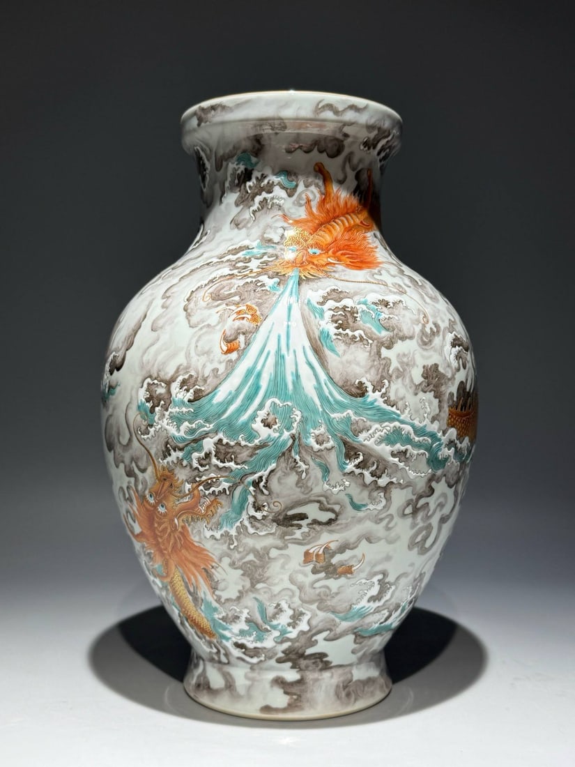 A famille rose olive-shaped vase with a design of a dragon: A famille rose olive-shaped vase with a design of a dragon teaching its son amidst clouds and waves, bearing the mark of the Yongzheng period of the Qing dynasty. Height: 31.2cm Width: 19.5cm