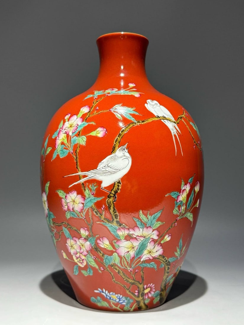 A Qing Dynasty Qianlong period enamel-painted coral-red ground olive-shaped vase: A Qing Dynasty Qianlong period enamel-painted coral-red ground olive-shaped vase with floral and bird motifs. Height: 26.3cm Width: 16cm