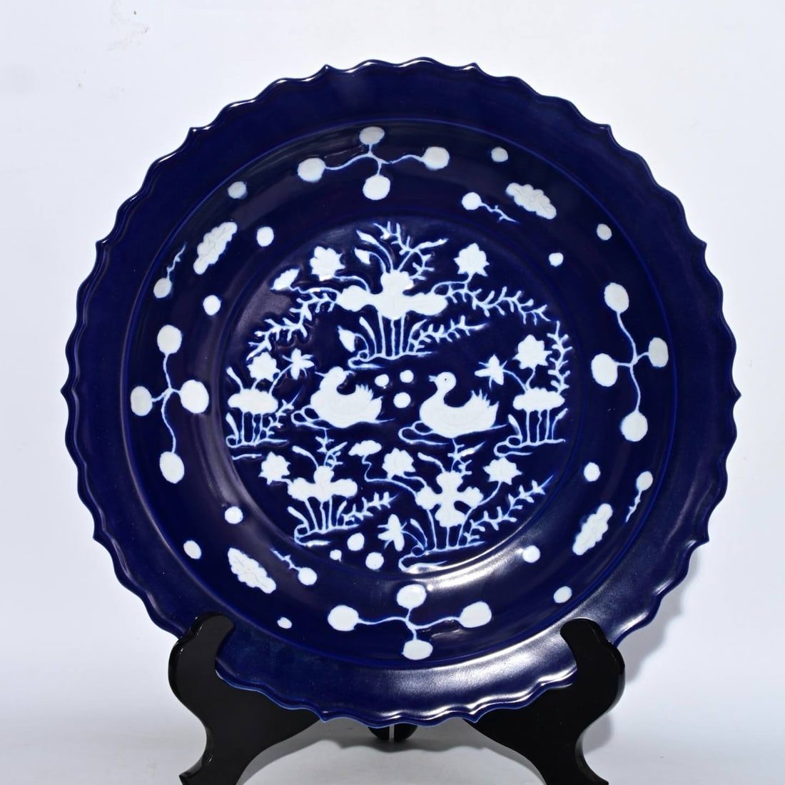 A Yuan Dynasty sacrificial blue glazed plate: A Yuan Dynasty sacrificial blue glazed plate with carved mandarin duck design in white glaze, 7.7 x 43 cm in height.