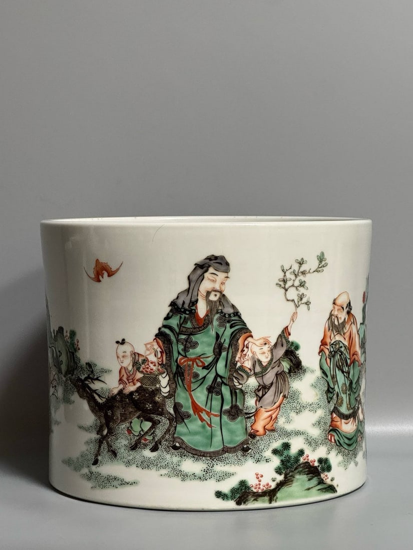A polychrome brush pot depicting figures and scenes from the Kangxi period of the Qing dynasty: A polychrome brush pot depicting figures and scenes from the Kangxi period of the Qing dynasty, 15.5 cm high and 19.5 cm in diameter.