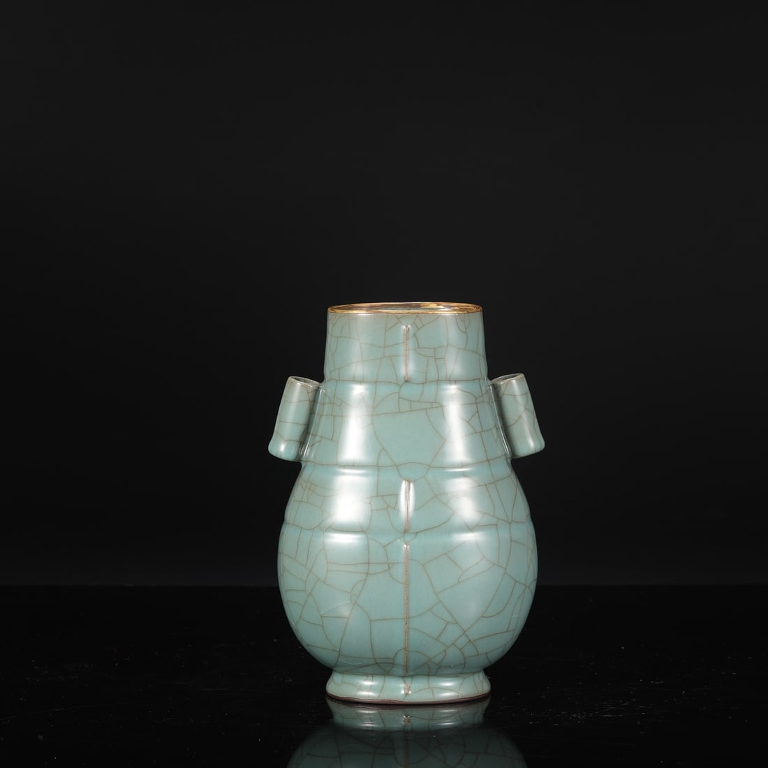 A Southern Song Dynasty official kiln celadon vase with gold-inlaid ribbed handles, from the: Dimensions: Height 22.5 cm, Mouth Diameter 8.5 cm, Belly Diameter 14 cm.