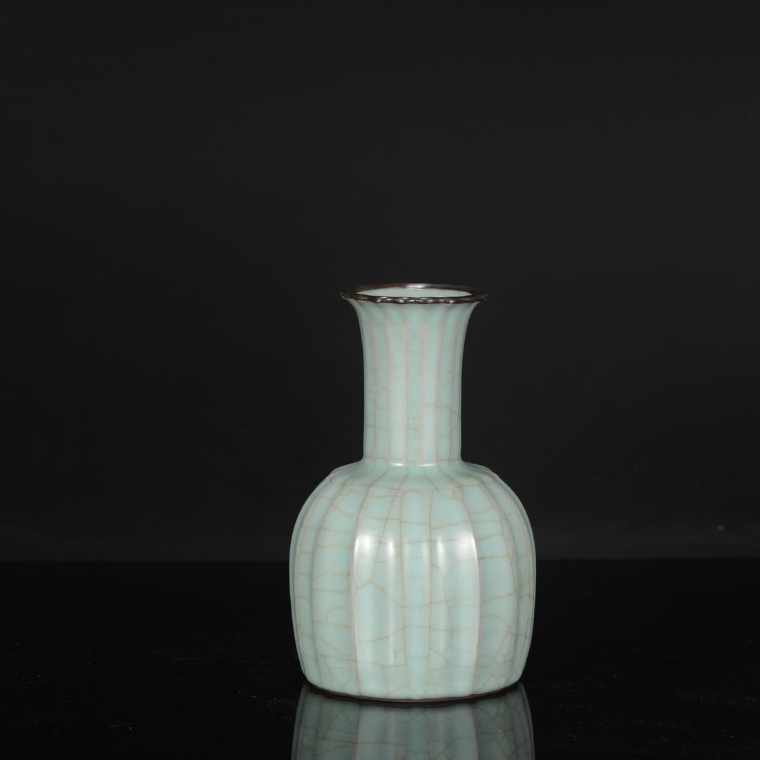 A Southern Song Dynasty official kiln celadon vase with silver-inlaid bell-shaped rim, formerly in: Dimensions: Height 22 cm, Mouth diameter 8 cm, Belly diameter 13 cm.