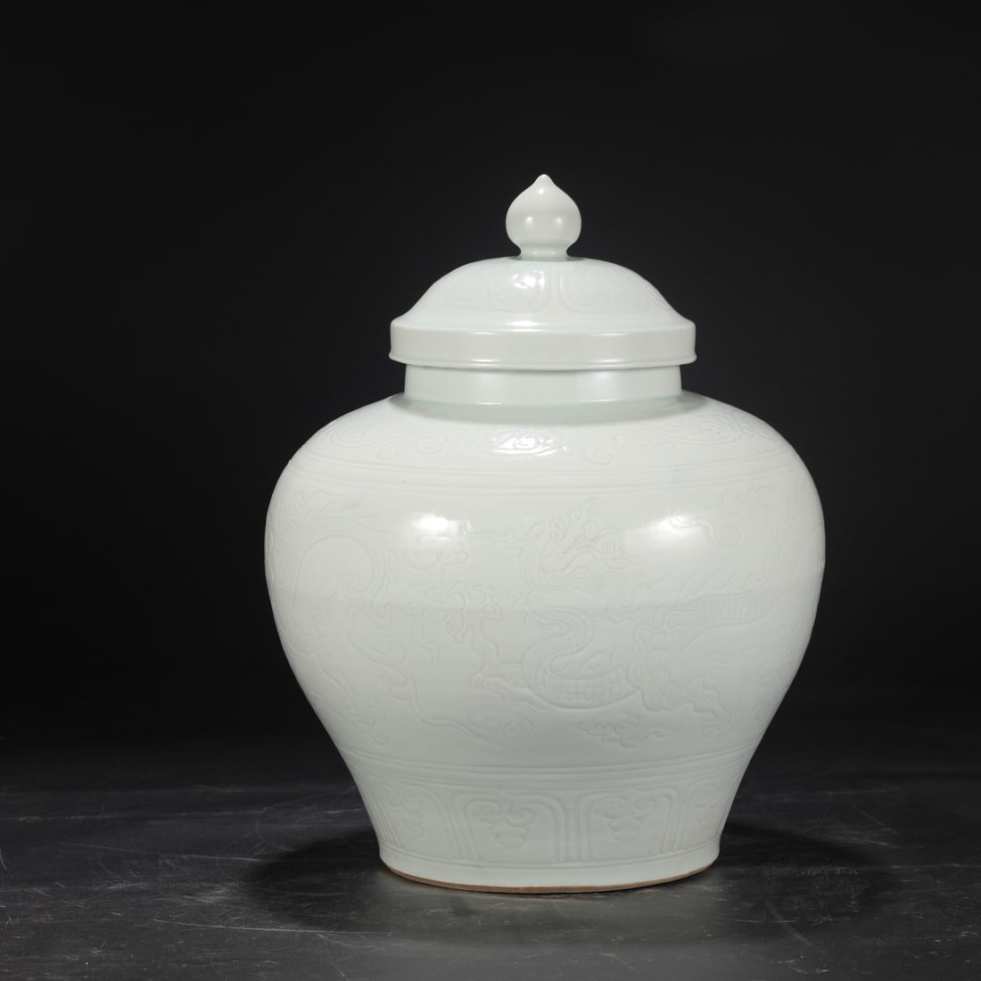 A Southern Song Dynasty Hutian kiln celadon jar with carved cloud and dragon design, formerly in the (1 of 8)