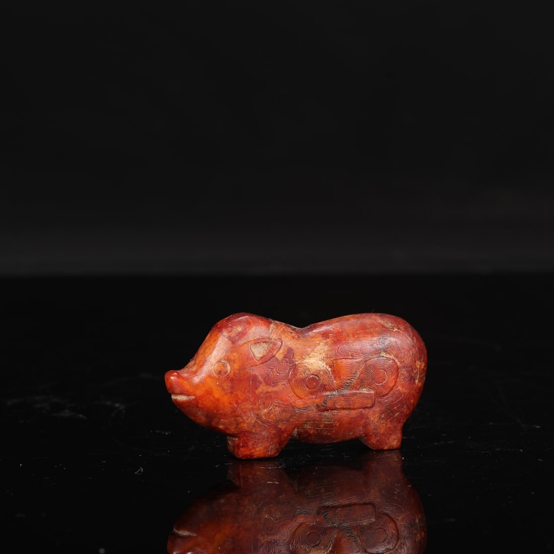 Jade pig with animal mask design from the Liangzhu culture (formerly in the collection).: Length: 8.5 cm, Width: 4.5 cm